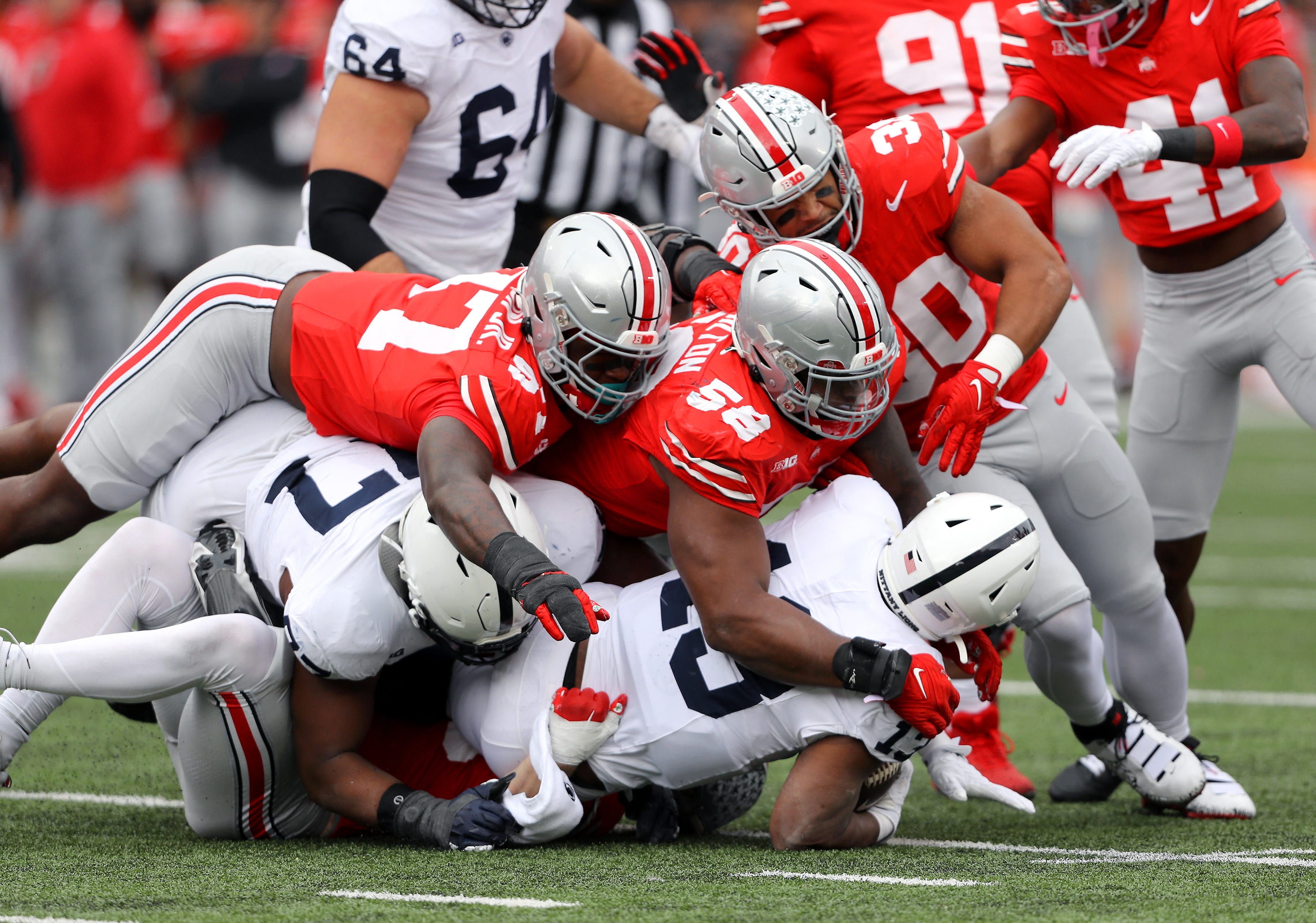 Penn State running back Kaytron Allen (13) is tackled by Ohio State defenders during their 2023 game at Ohio Stadium.