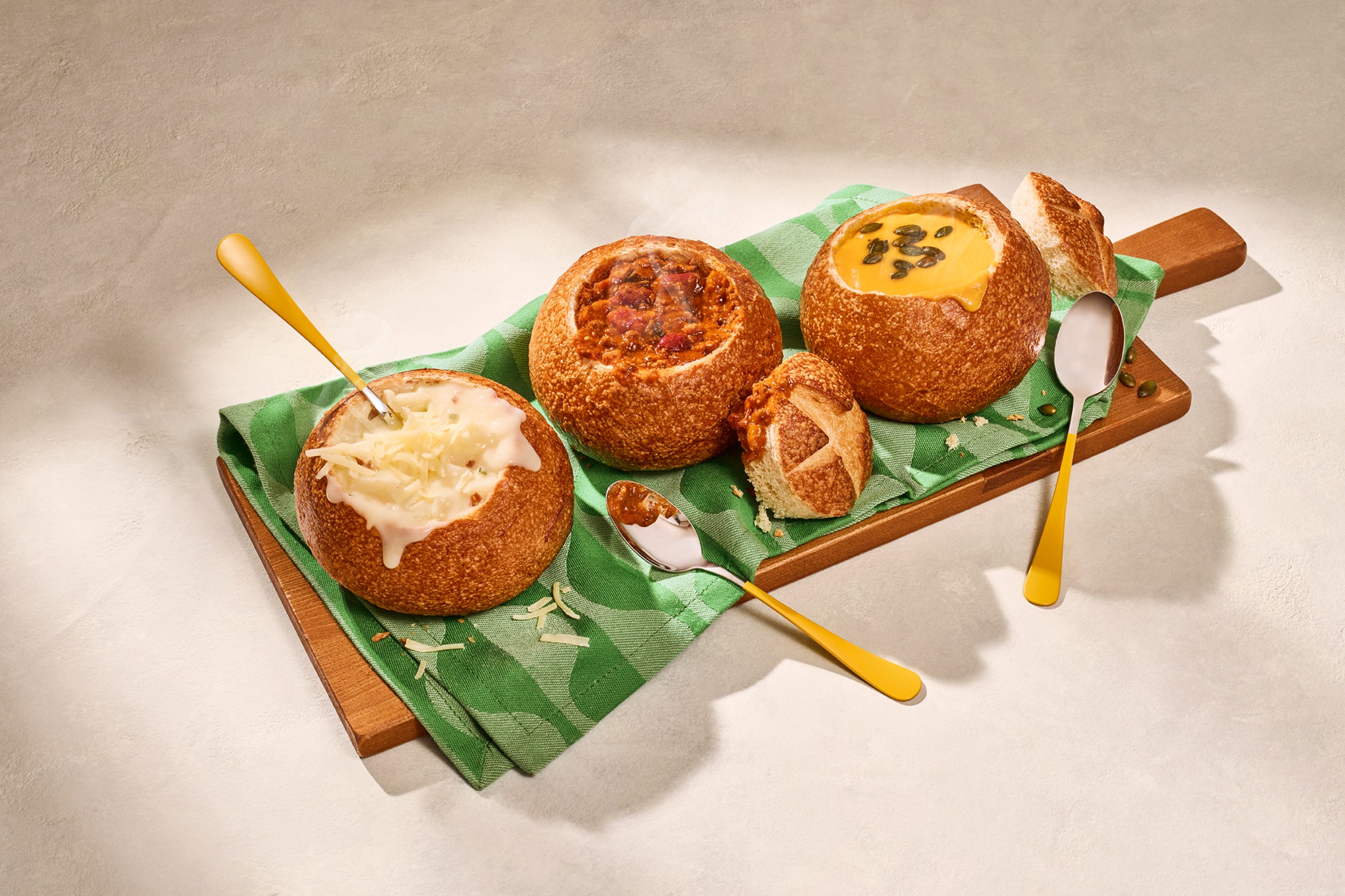 From left to right, Panera Bread's Rustic Baked Potato Soup, Hearty Fireside Chili and Autumn Squash Soup.