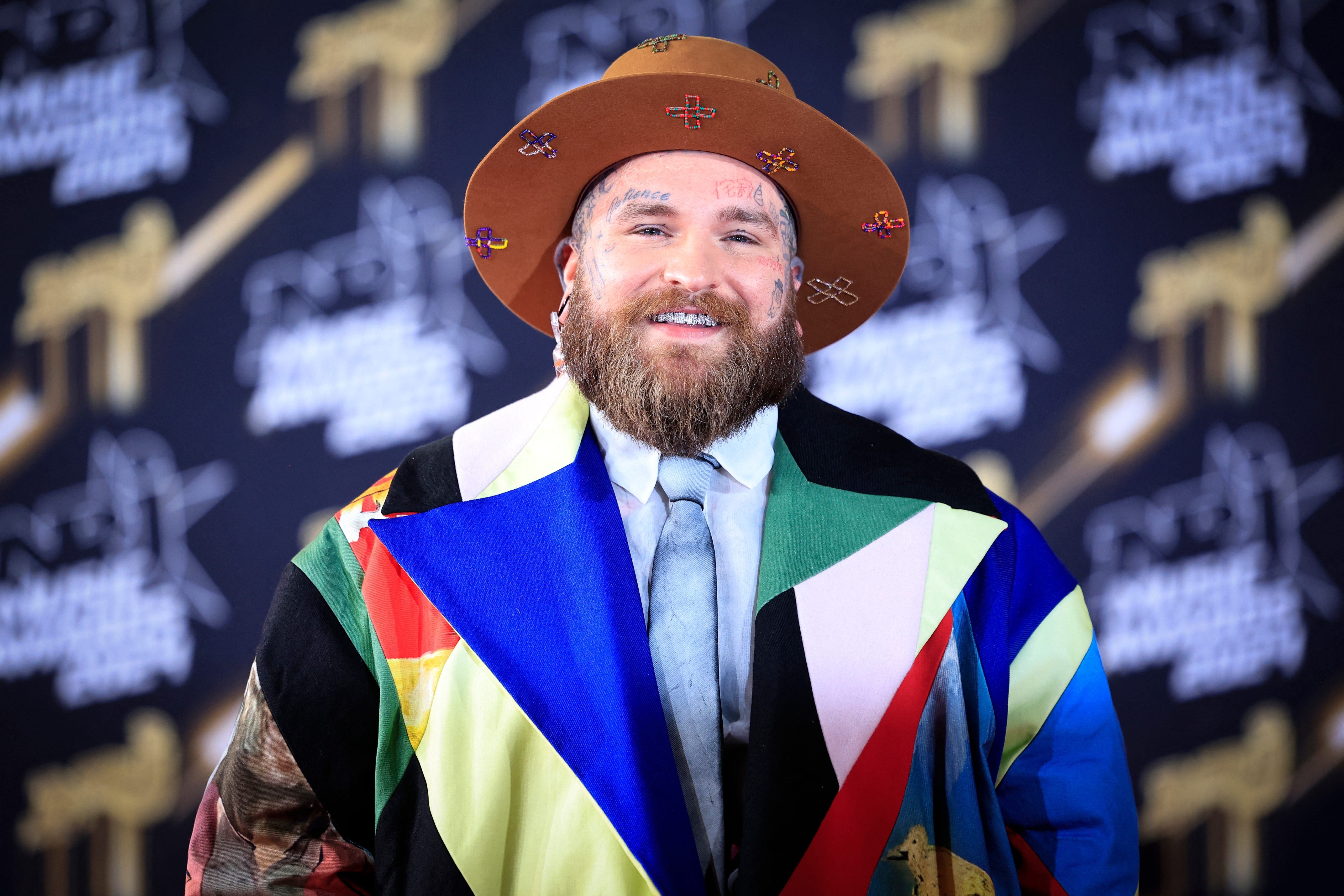 Teddy Swims poses on the red carpet at the NRJ Music Awards ceremony at the Palais des Festivals in France Nov. 1, 2024. The singer is among the best new artist nominees for the 2025 Grammy Awards.