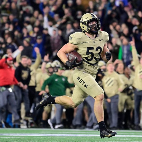 Army linebacker Kalib Fortner (53) returns a fumble for a touchdown during the second half against Navy at Gillette Stadium on Dec. 9, 2023.