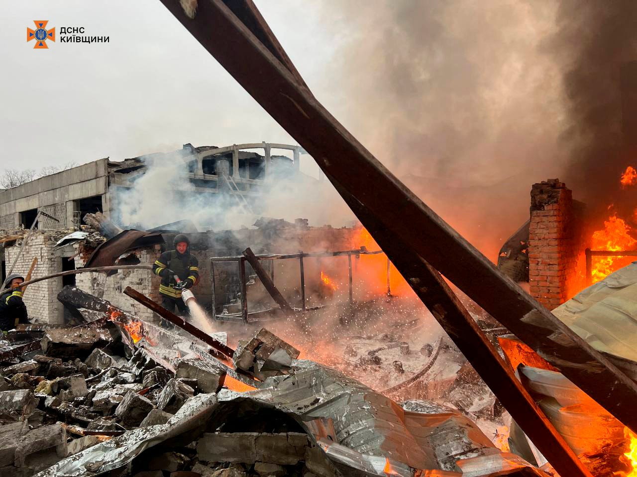 Firefighters work at the site where an industrial area was hit by a Russian missile strike in the Kyiv region of Ukraine, on Nov. 13, 2024.