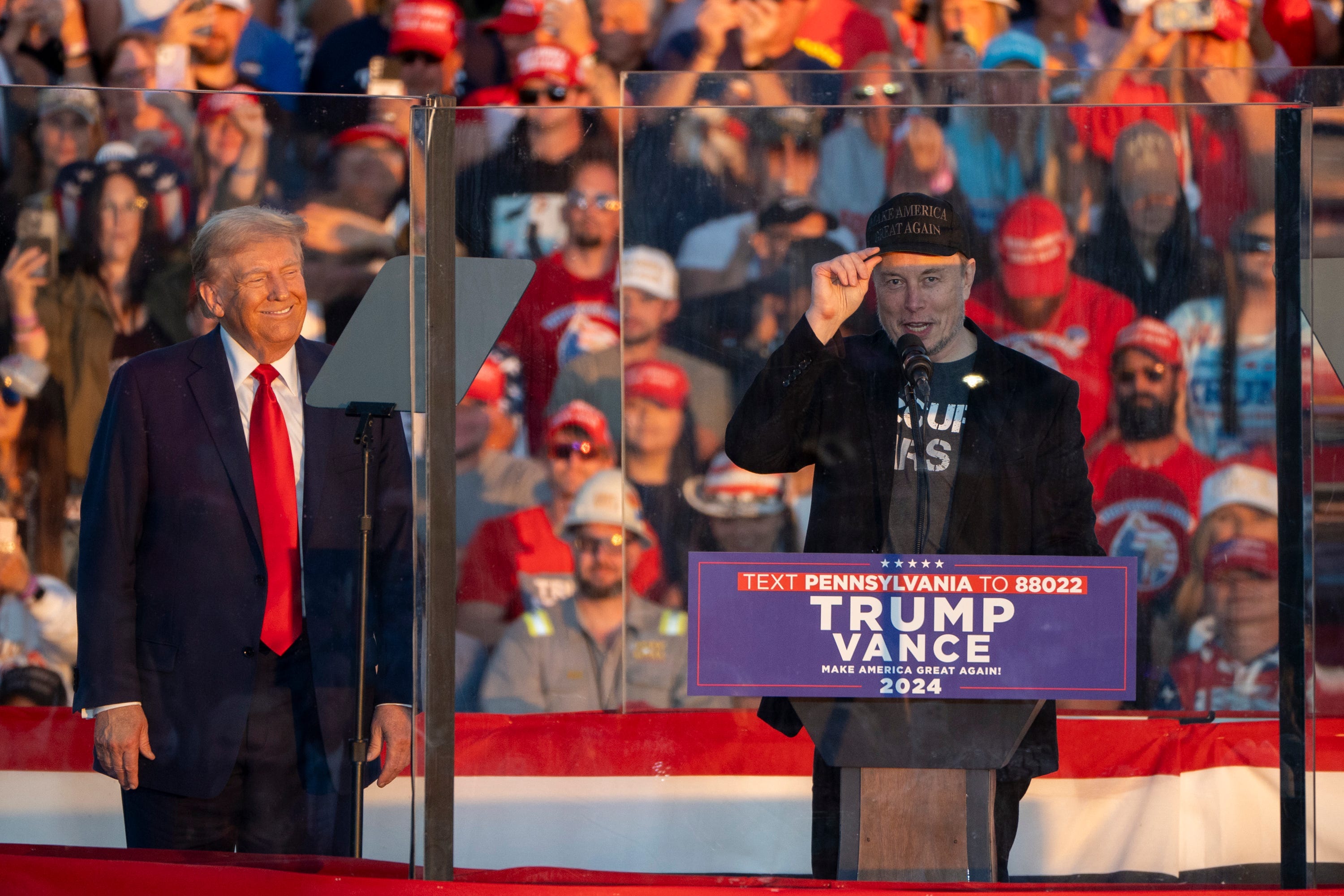 Elon Musk joins former President Donald Trump on stage as Trump speaks at a campaign rally in Butler, Pa., on Oct. 5, 2024.