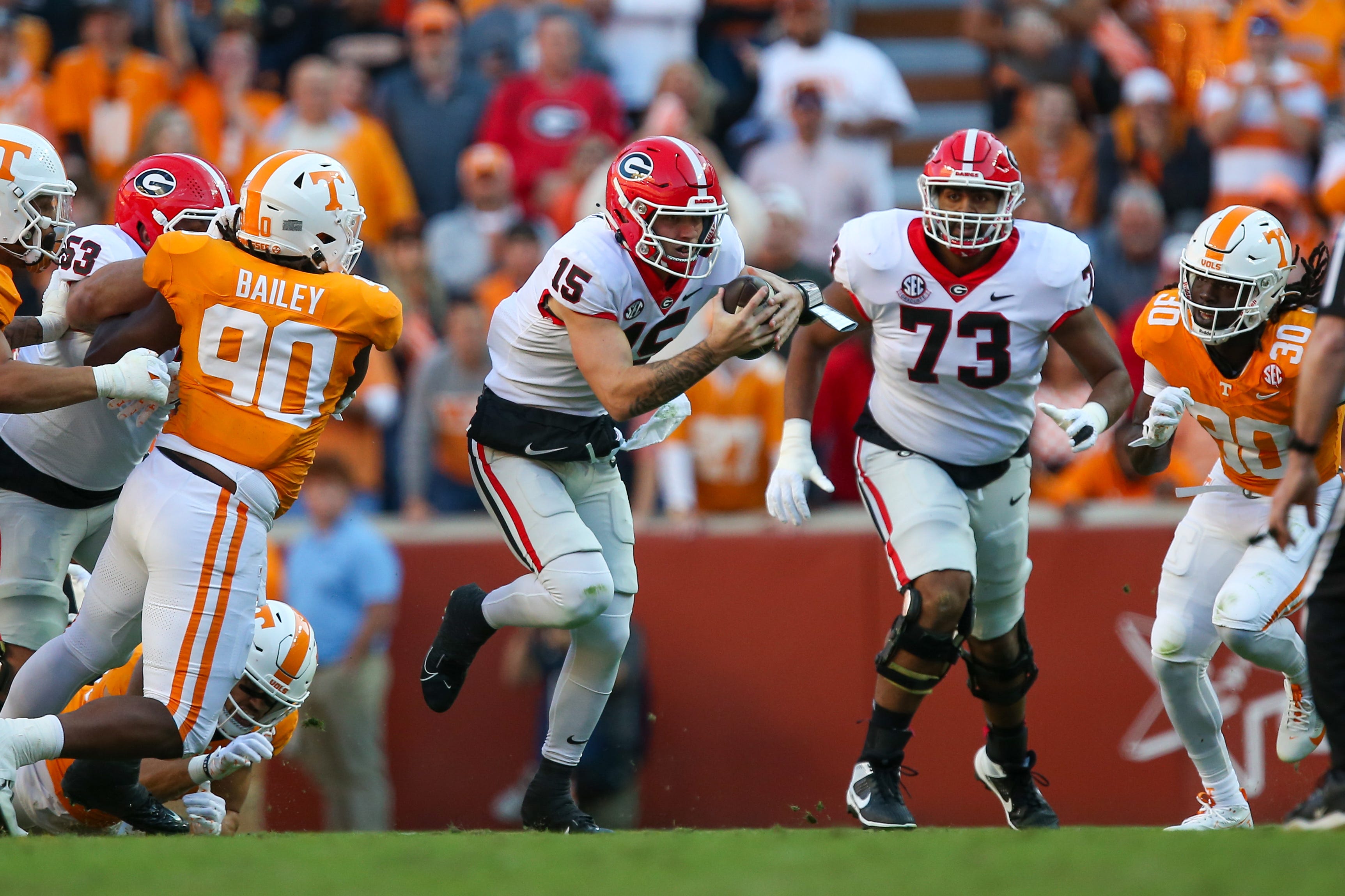 Georgia quarterback Carson Beck (15) runs the ball against Tennessee during their 2023 game at Neyland Stadium.