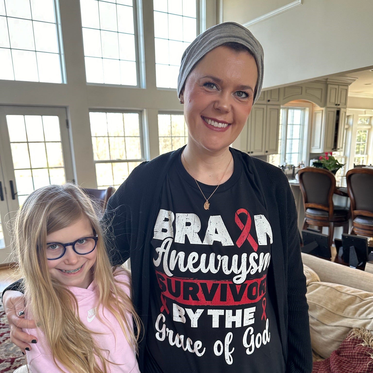 Julianne Smith with her daughter. Smith had a grade 5 brain aneurysm in January 2024. She survived it, but had to learn how to speak, walk and regain her independence in the months after her medical emergency.