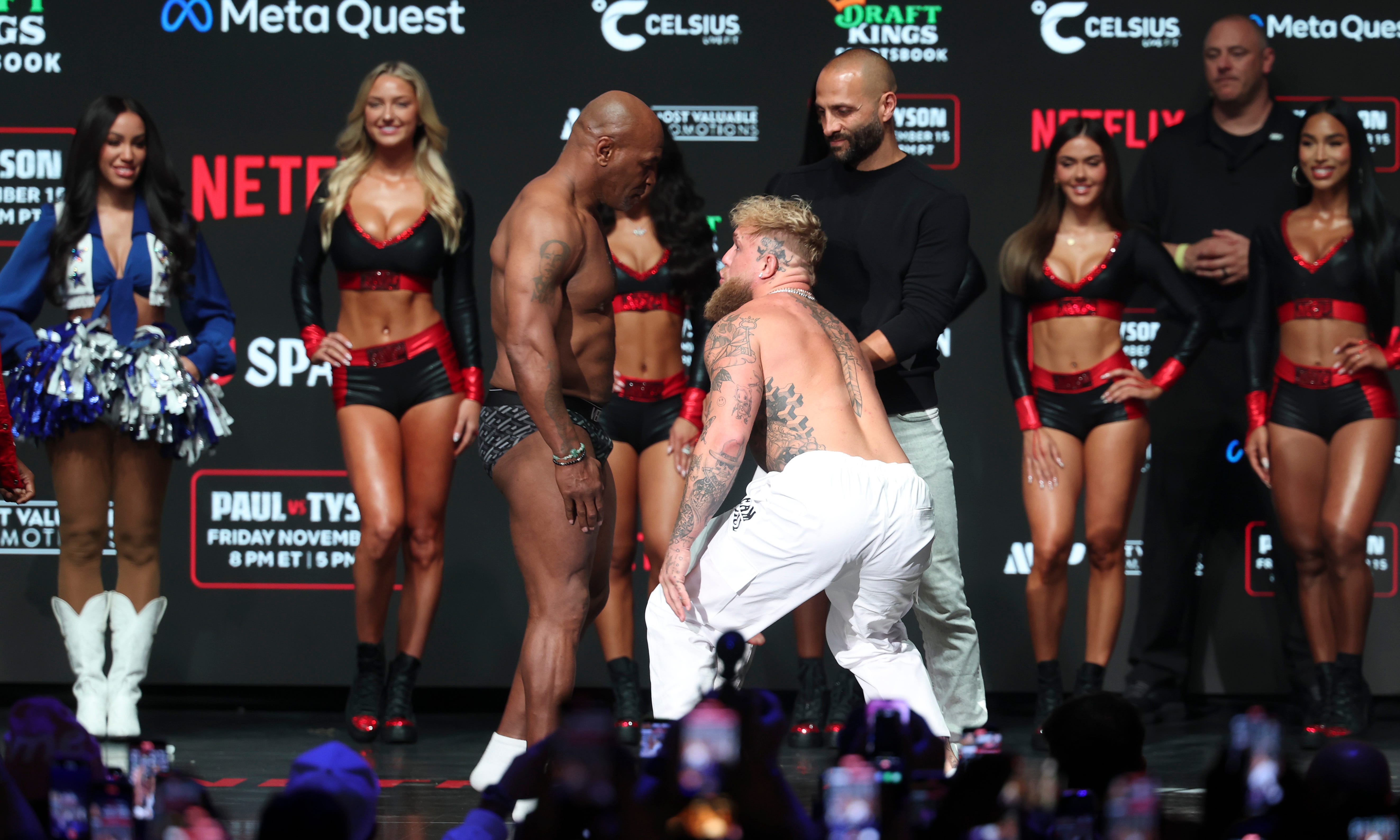 Jake Paul, right, and Mike Tyson face off during weigh-ins at the Toyota Music Factory the day before their fight.