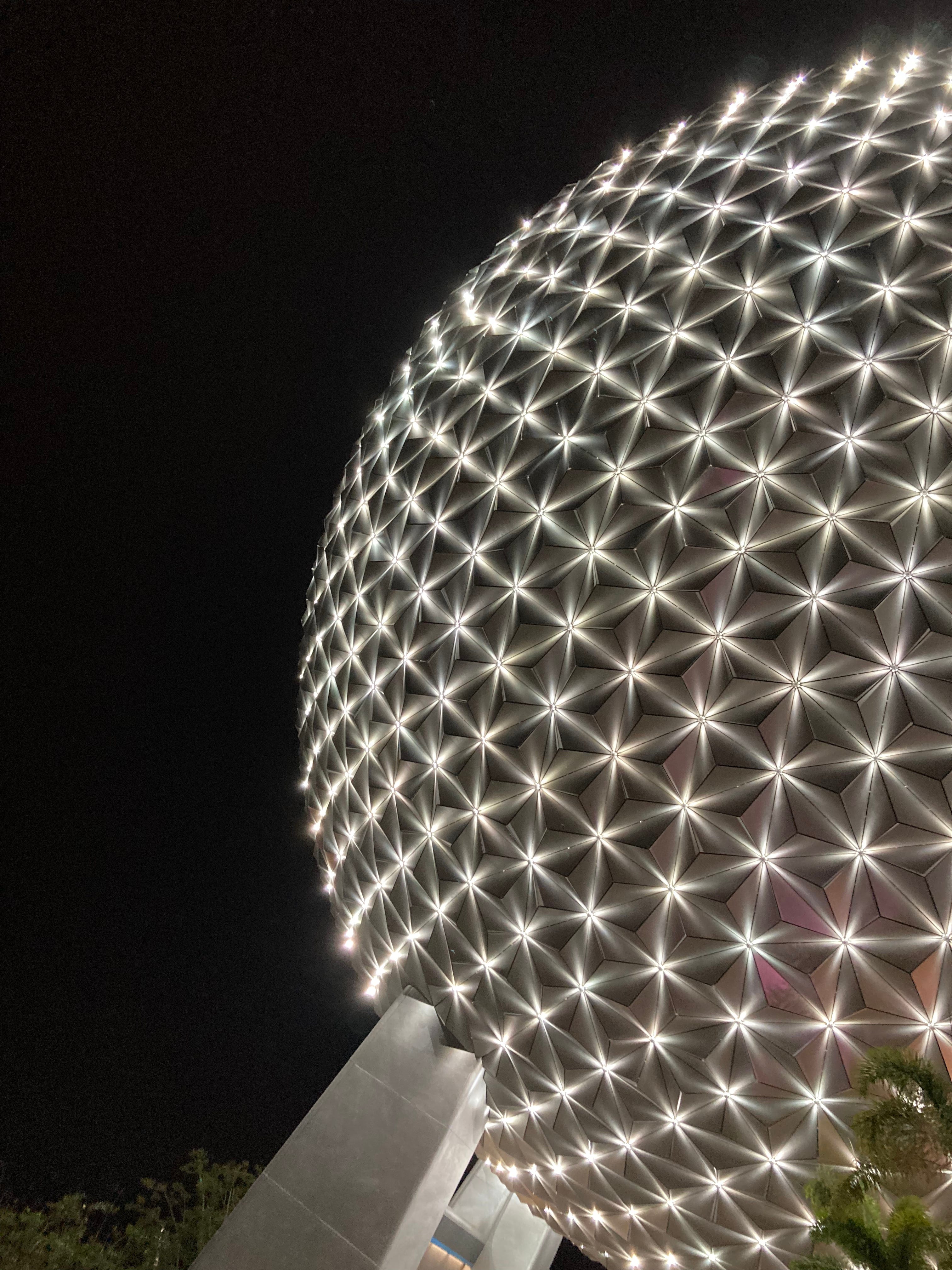 EPCOT's Spaceship Earth sparkles at night.