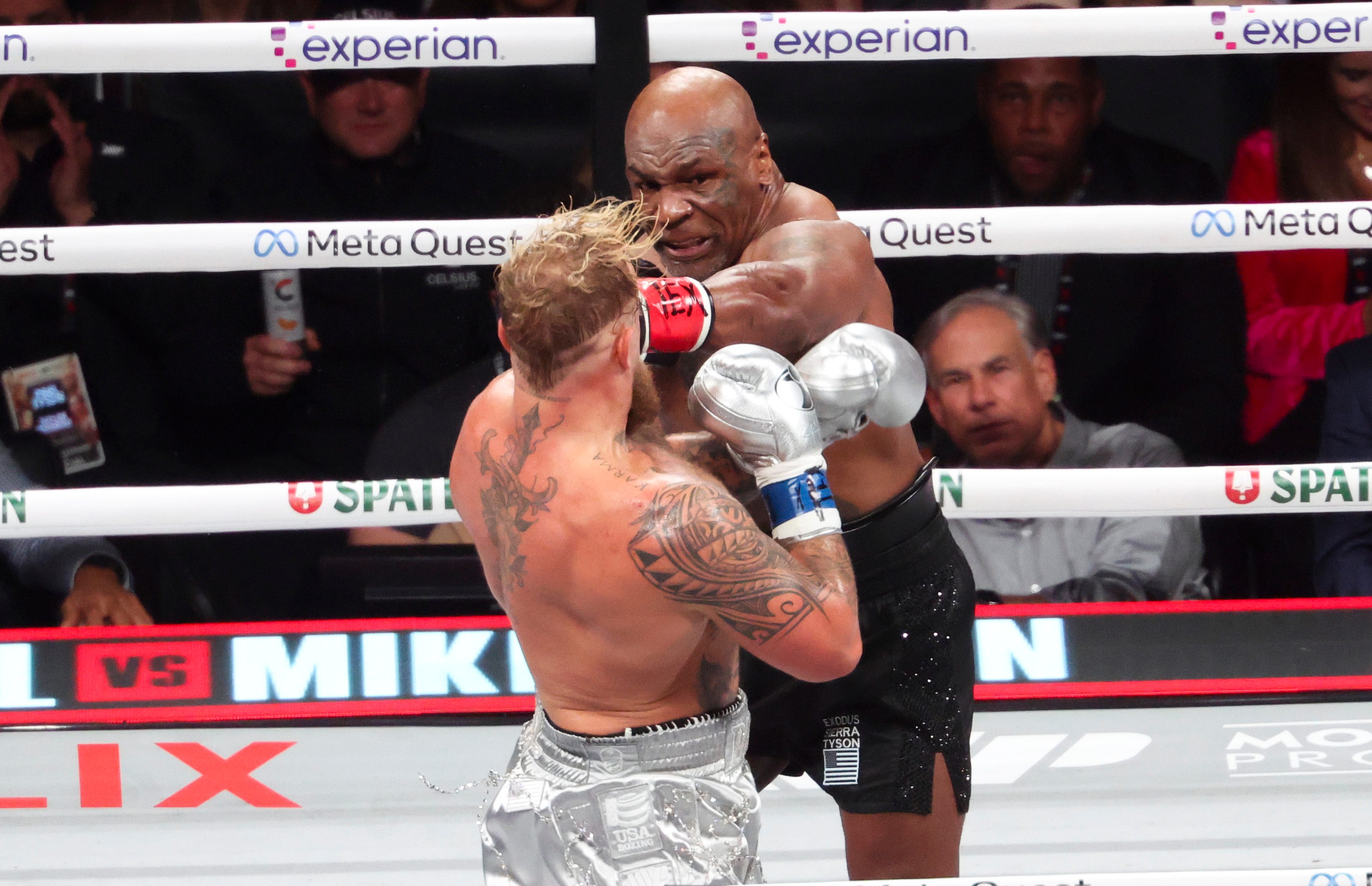 Mike Tyson throws a punch at Jake Paul at AT&T Stadium.