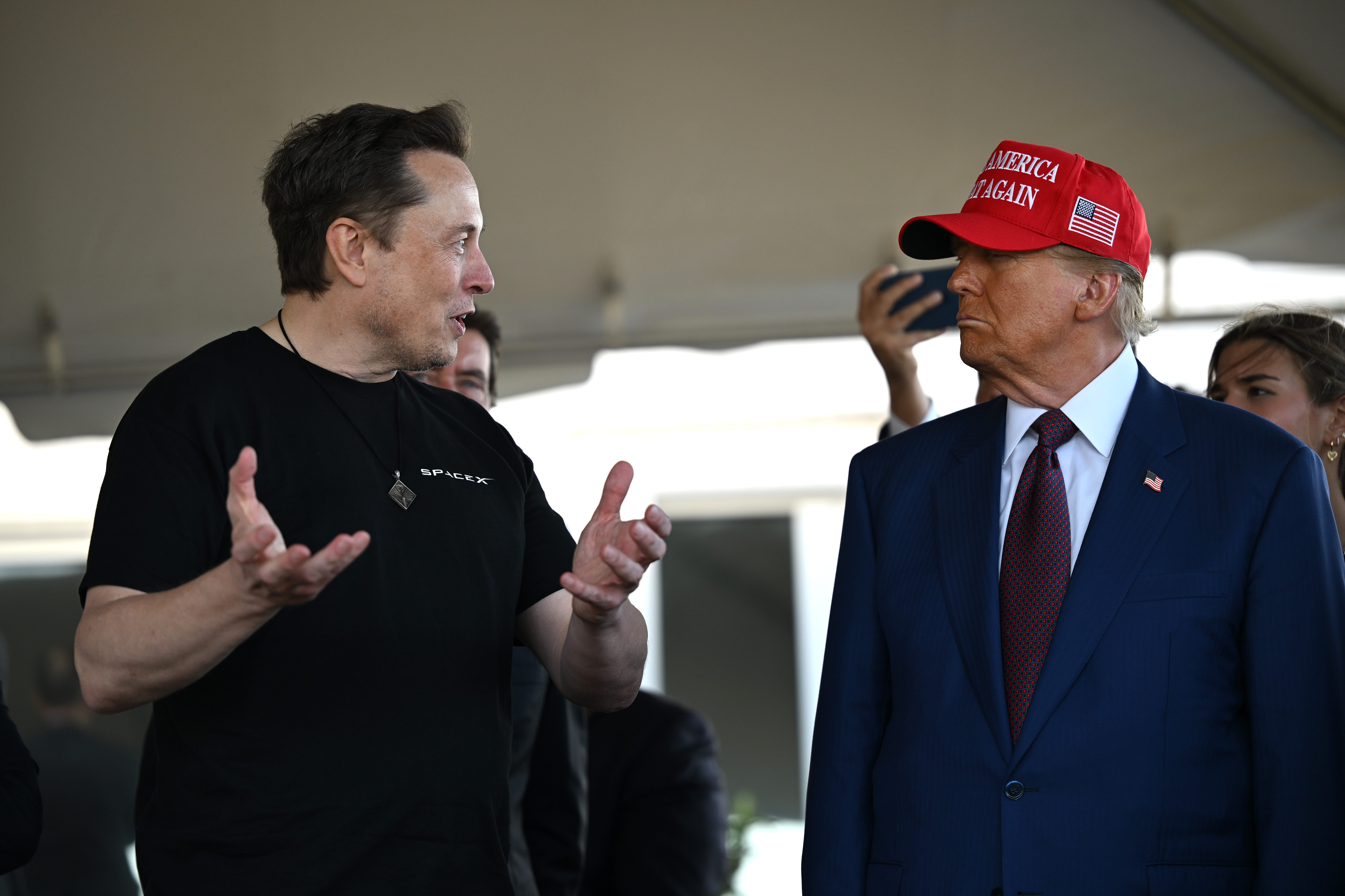 Elon Musk speaks with U.S. President-elect Donald Trump at a viewing of the launch of the sixth test flight of the SpaceX Starship rocket on November 19, 2024 in Brownsville, Texas. SpaceX's billionaire owner, Elon Musk, a Trump confidante, has been tapped to lead the new Department of Government Efficiency alongside former presidential candidate Vivek Ramaswamy. (Photo by Brandon Bell/Getty Images)