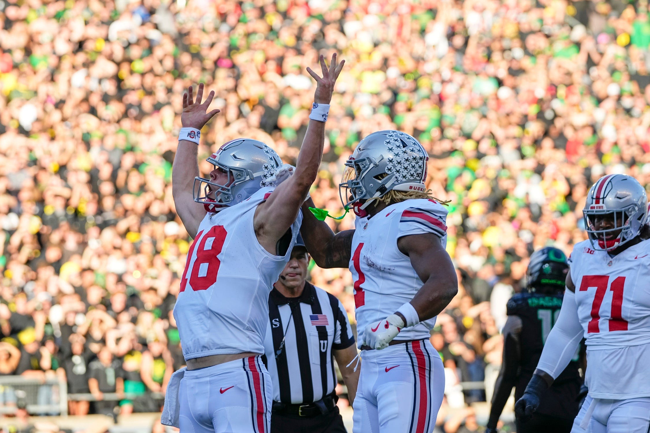 Oct 12, 2024; Eugene, Oregon, USA; Ohio State Buckeyes quarterback Will Howard (18) celebrates scoring a touchdown during the first half of the NCAA football game against the Oregon Ducks at Autzen Stadium