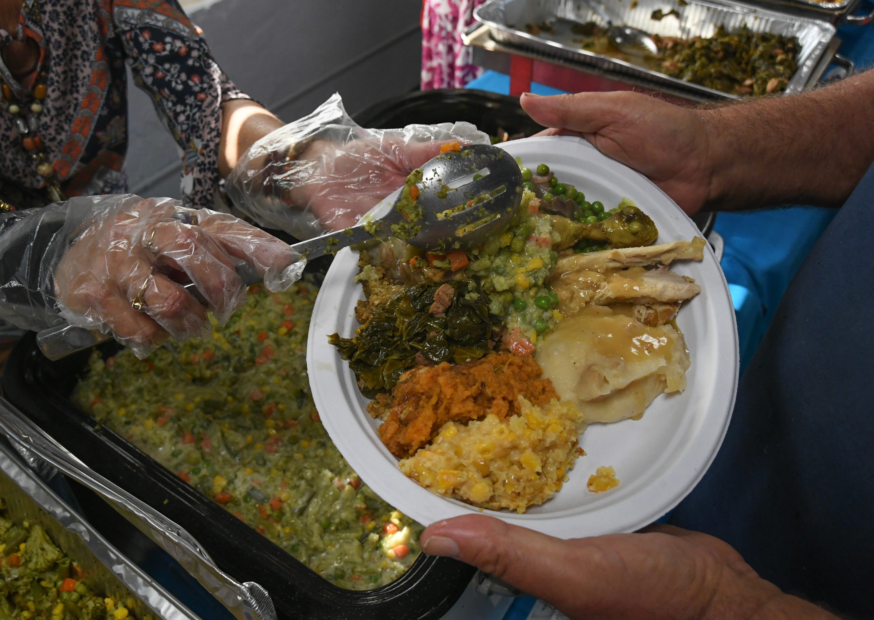 Fairlawn Church members and volunteers help out to feed upwards to 300 community members during their Thanksgiving Day dinner event on Thursday, Nov. 23, 2023, in Fort Pierce, Florida.
