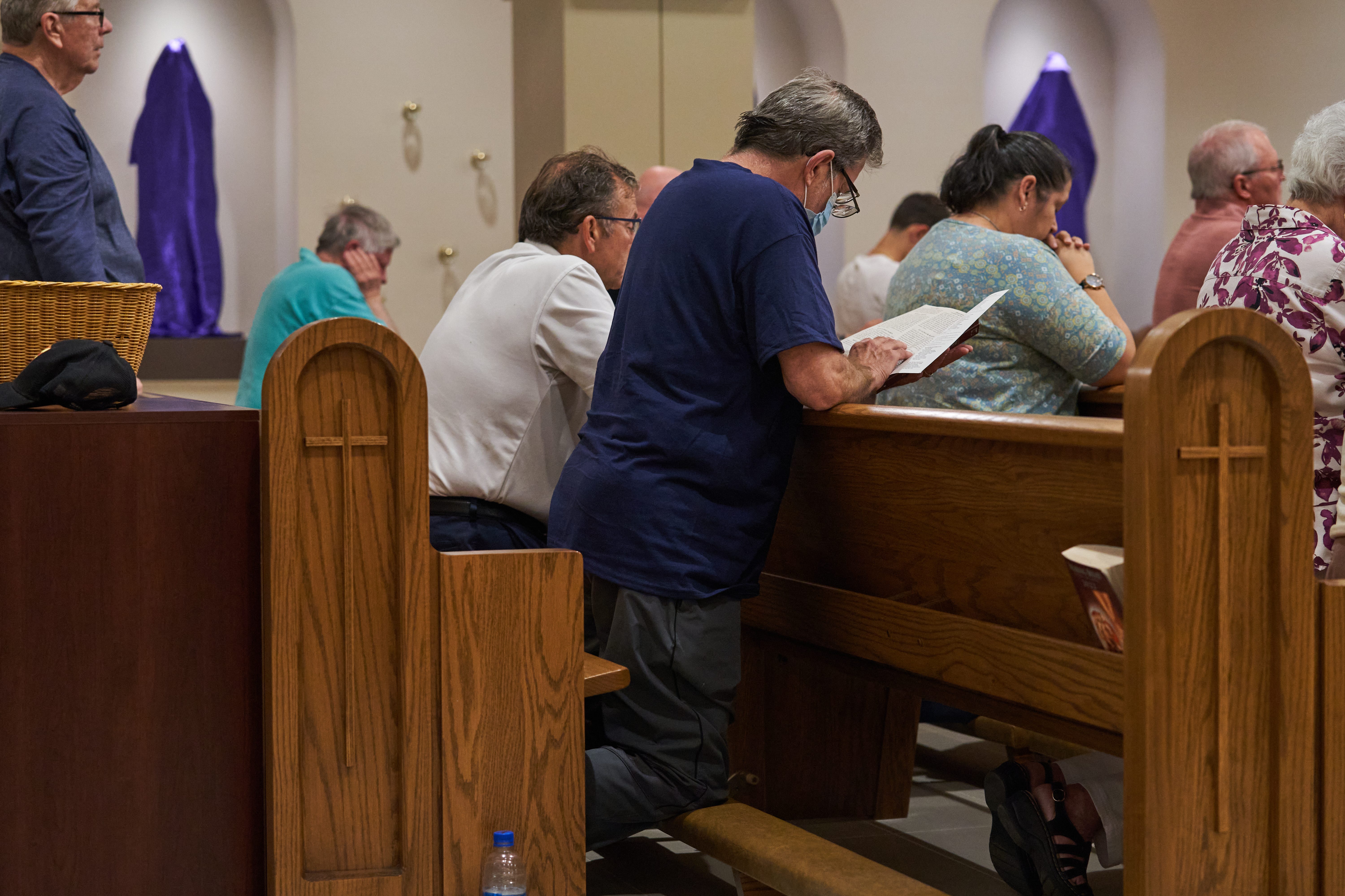 Jim Keegan kneels in the pew during Mass at St. Joseph Catholic Church on April 14, 2022, in Phoenix.    News St Joe Easter