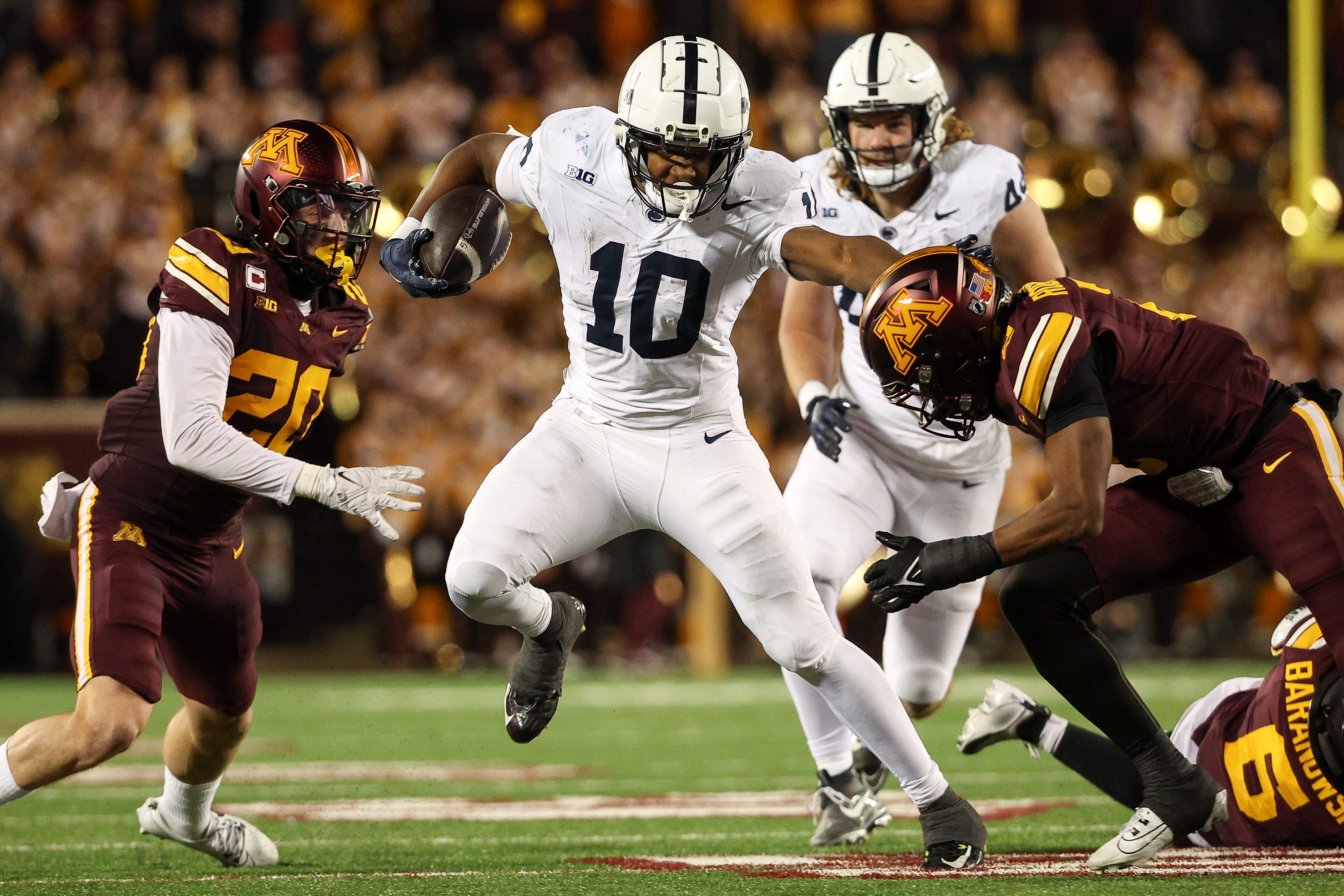 Penn State running back Nicholas Singleton (10) runs the ball against Minnesota during the third quarter at Huntington Bank Stadium.