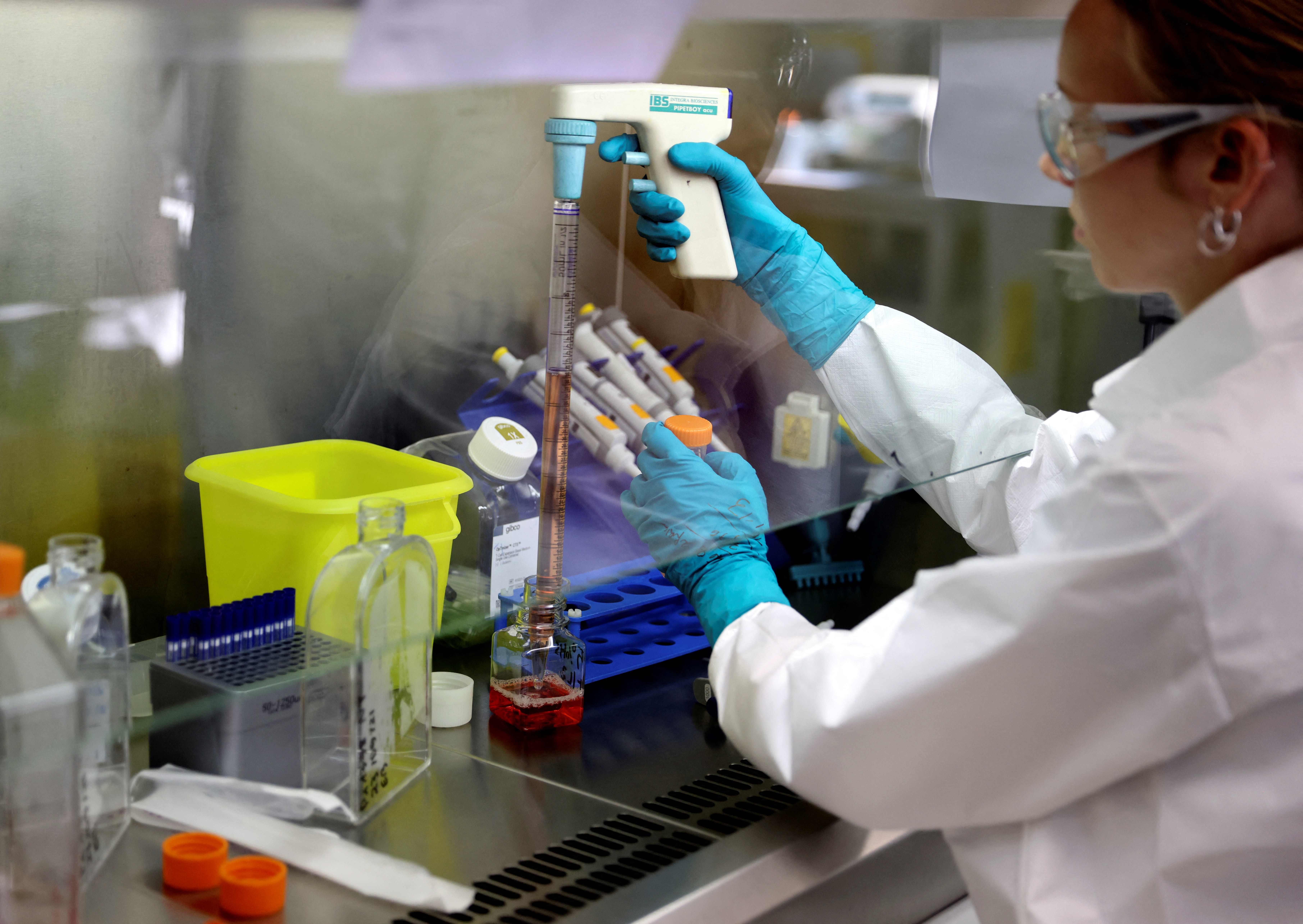 A lab technician works on a research process to find new CAR T cells in Paris in 2021. 