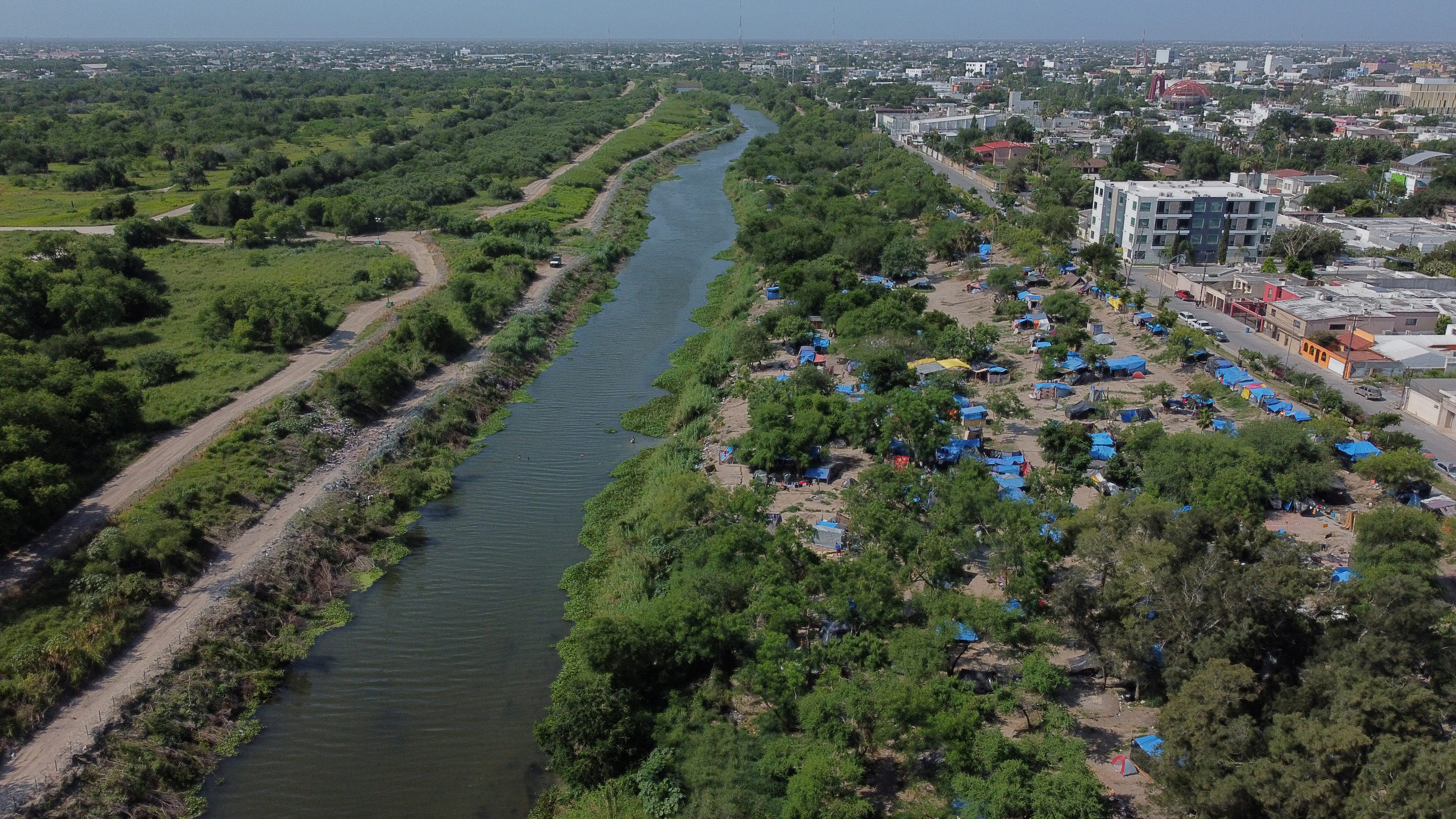 A makeshift camp, where asylum seekers wait as they attempt to cross into the U.S. by an appointment through the Customs and Border Protection app, called CBP One, lines the Rio Grande river border between Brownsville, Texas and Matamoros, in Matamoros, Mexico June 20, 2023. President Joe Biden promised to replace the hardline policies of former President Donald Trump, including the COVID-era   public health order Title 42, with a more humane immigration system. The new Biden regulation allows migrants once again to ask for asylum at the border, but wait in Mexico for a slot on the app or risk a sped-up deportation process that could be conducted while they are held in detention. But in the first month of the new policy, Reuters found tens of thousands of people are waiting in dangerous Mexican border towns to snag a spot on the app, according to U.S. and Mexican officials, amid warnings from humanitarian groups of deteriorating sanitary conditions at migrant camps.  REUTERS/Daniel Becerril    SEARCH "BECERRIL GONZALEZ ASYLUM" FOR THIS STORY. SEARCH "WIDER   IMAGE" FOR ALL STORIES.