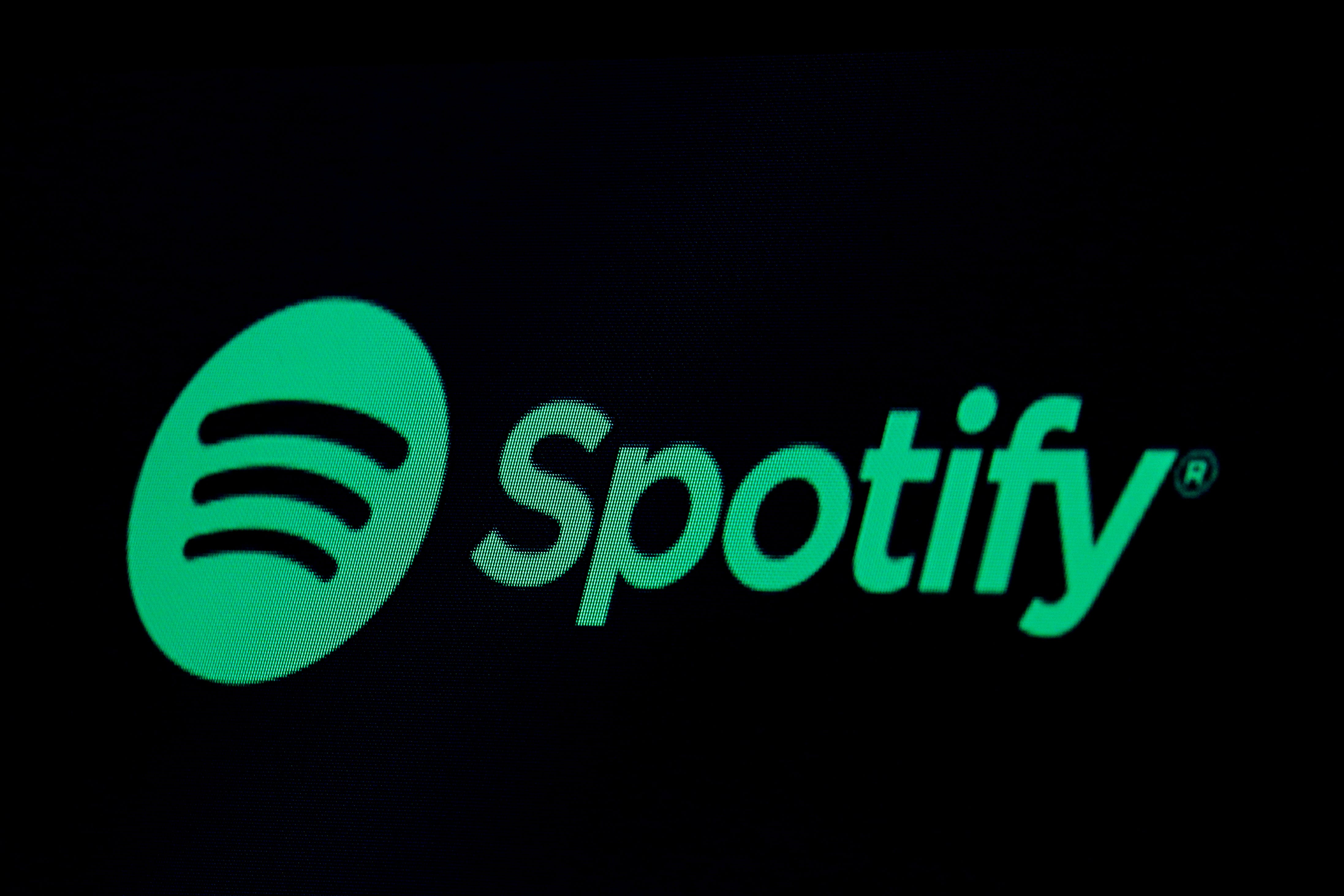 The Spotify logo is displayed on a screen on the floor of the New York Stock Exchange on May 3, 2018