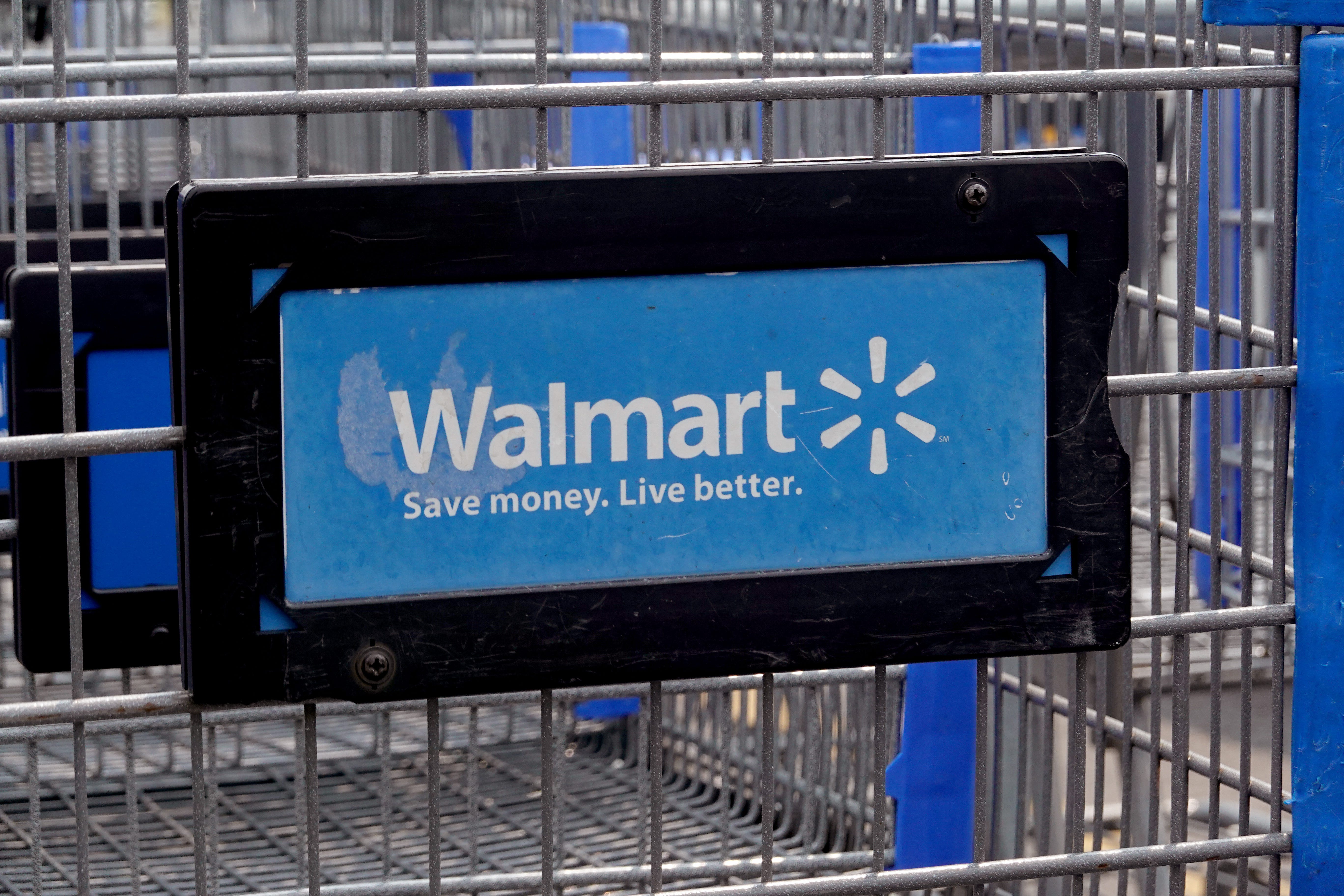 Walmart logo is shown on the front of shopping cart at a Walmart store on May 18, 2023 in Chicago, Illinois.