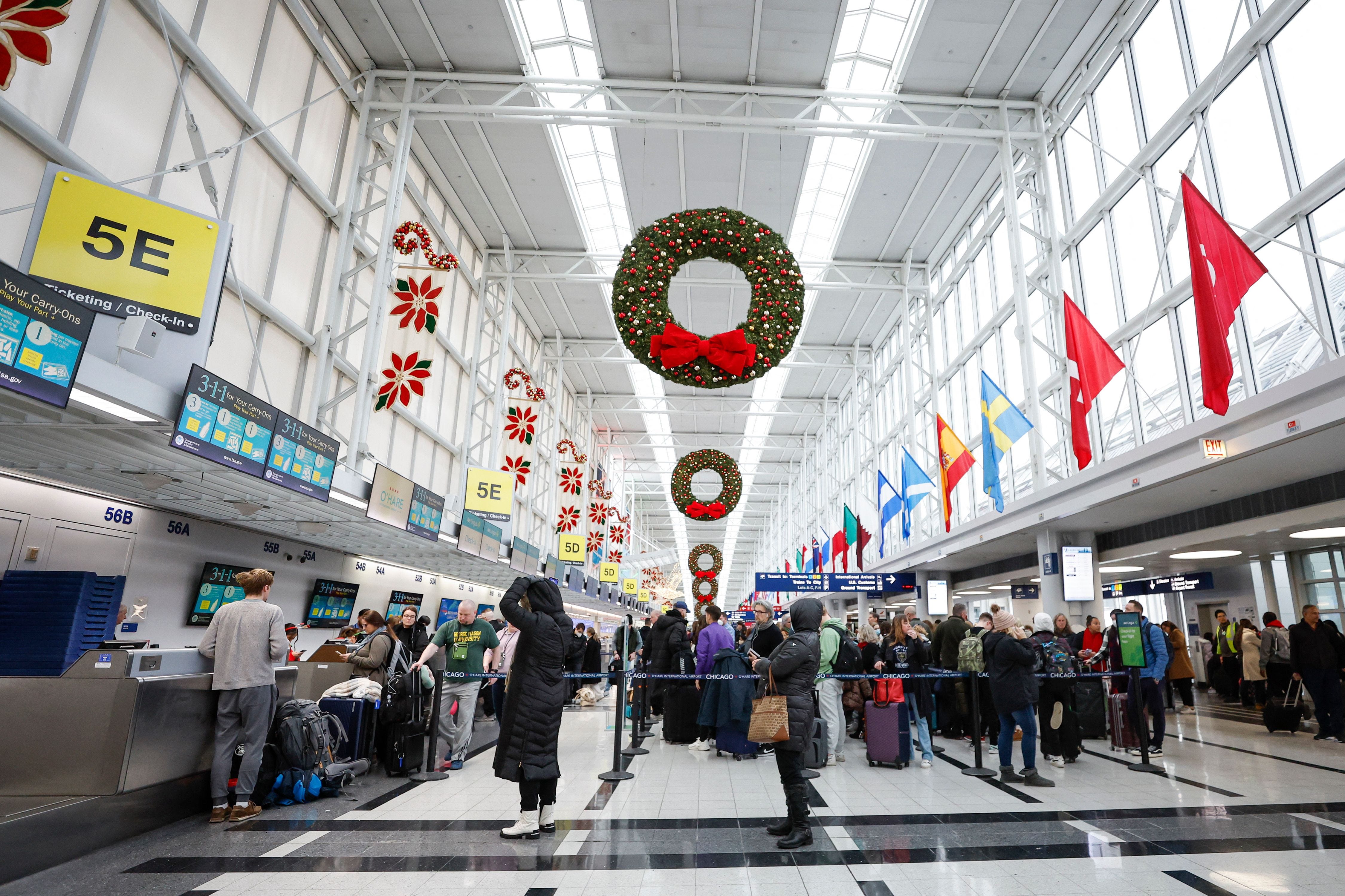 Travelers wait in line to check-in for their flight at Terminal 5 ahead of the Christmas holiday at O'Hare International Airport on December 22, 2022 in Chicago.