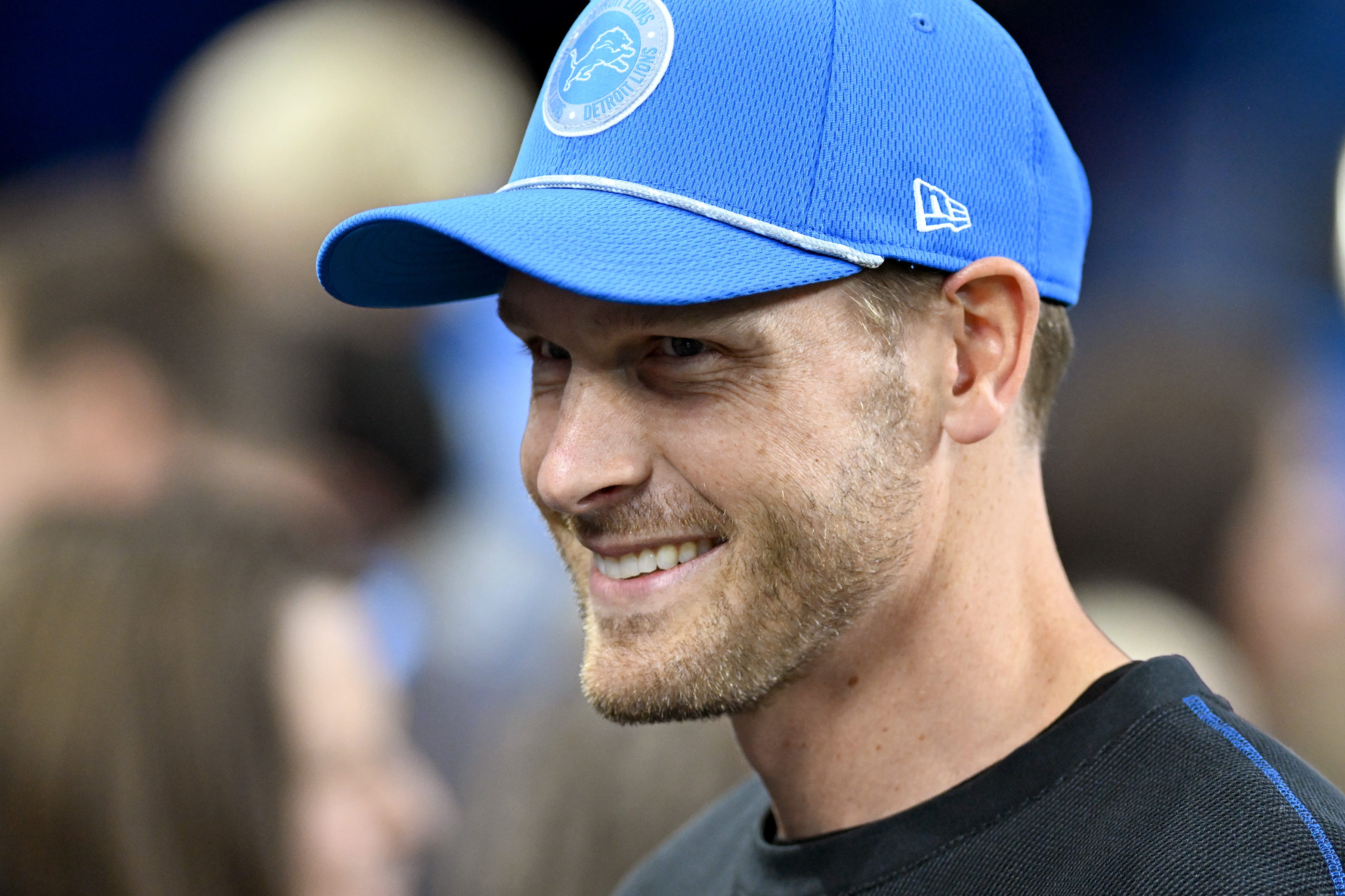 Detroit Lions offensive coordinator Ben Johnson talks with fans on the sidelines during pregame warmups before their game against the Chicago Bears at Ford Field.