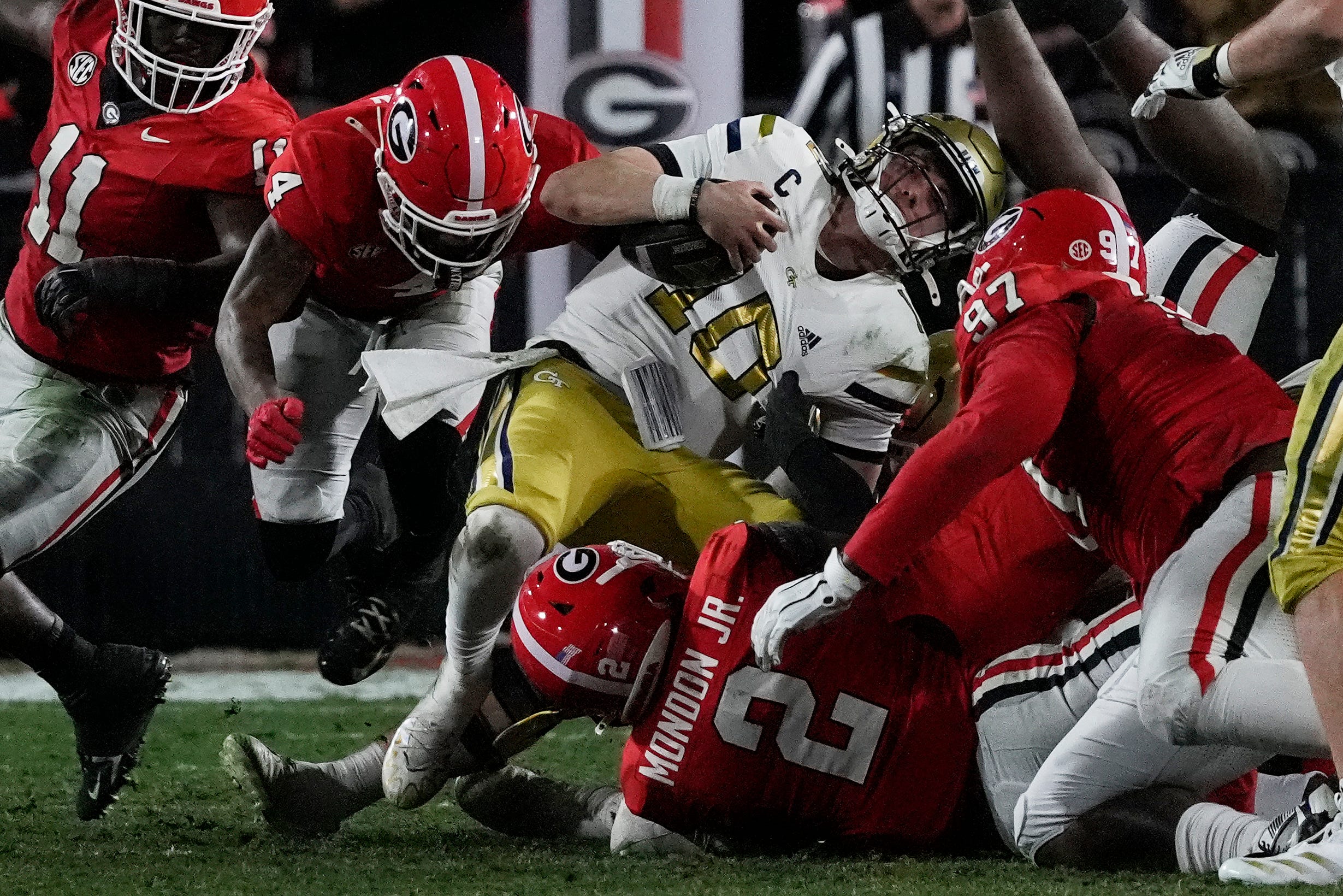 Georgia Tech quarterback Haynes King (10) is stopped by Georgia linebacker Smael Mondon Jr. (2) during the first half of a NCAA college football game against Georgia Tech in Athens, Ga., on Friday, Nov. 29, 2024.