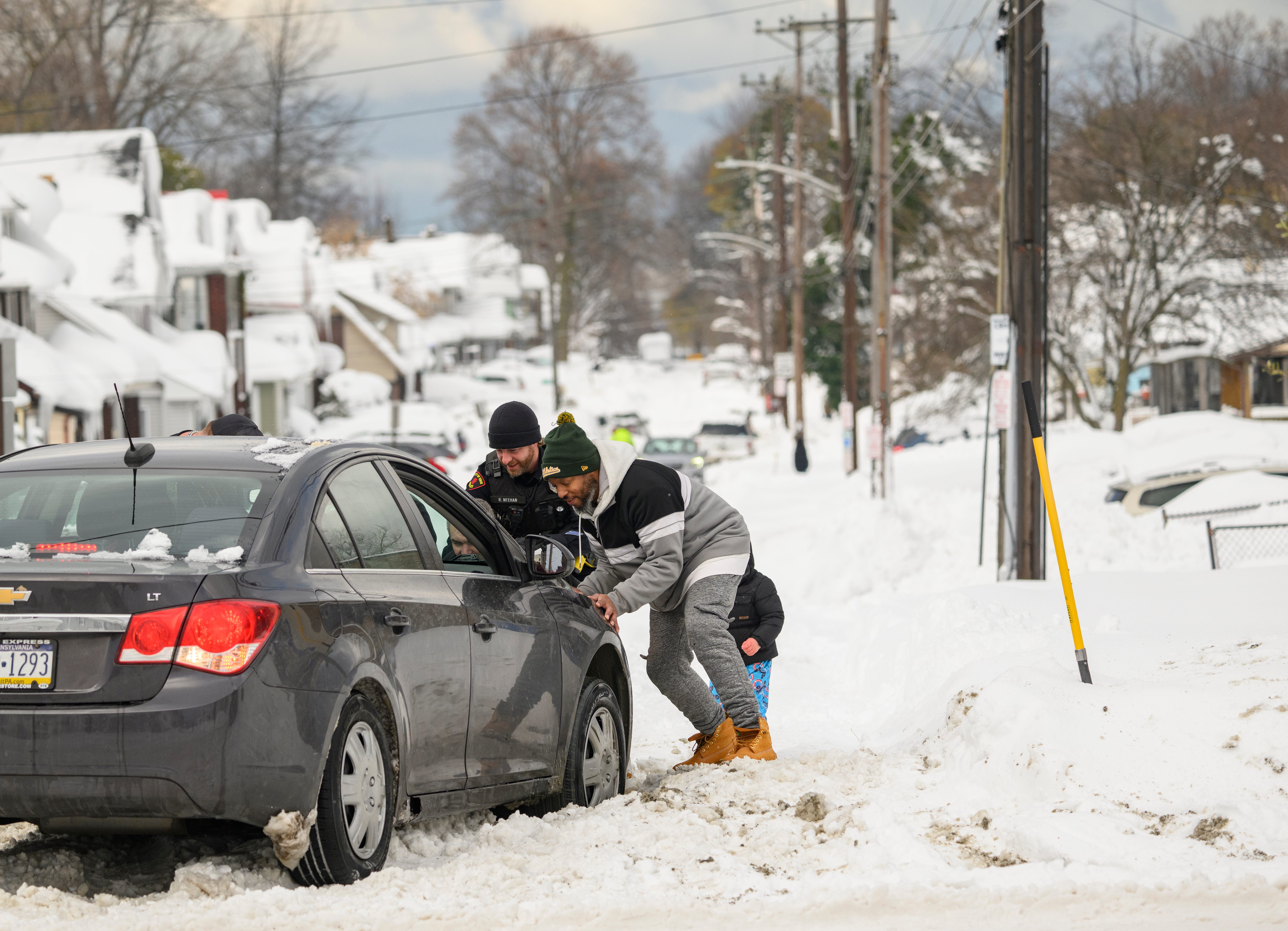 An Erie police officer assists a stranded motorist after on December 2, 2024 in Erie, Pennsylvania.