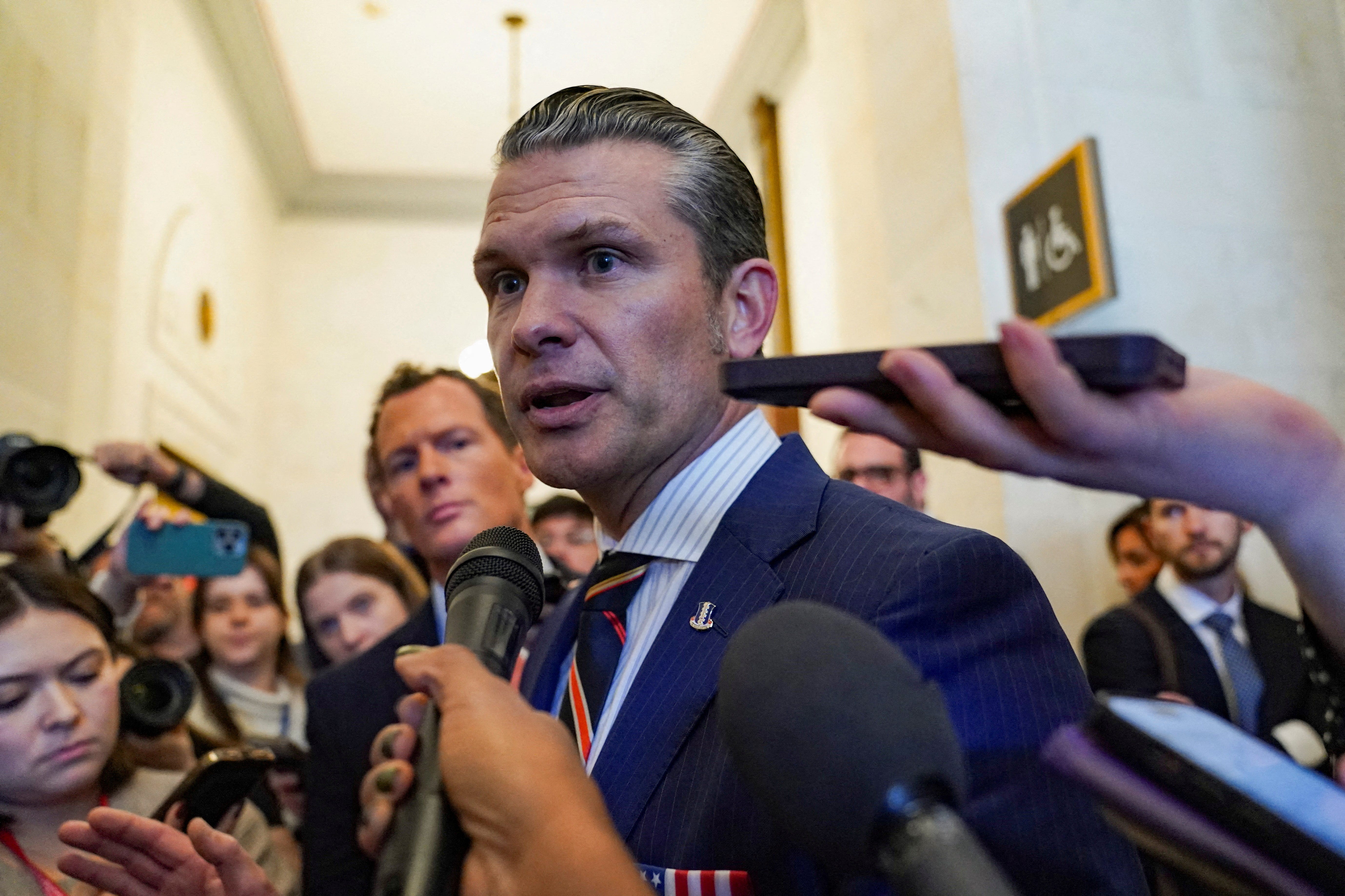 Defense secretary nominee Pete Hegseth speaks with the media as he departs a meeting on Capitol Hill in Washington, U.S., November 21, 2024. REUTERS/Nathan Howard