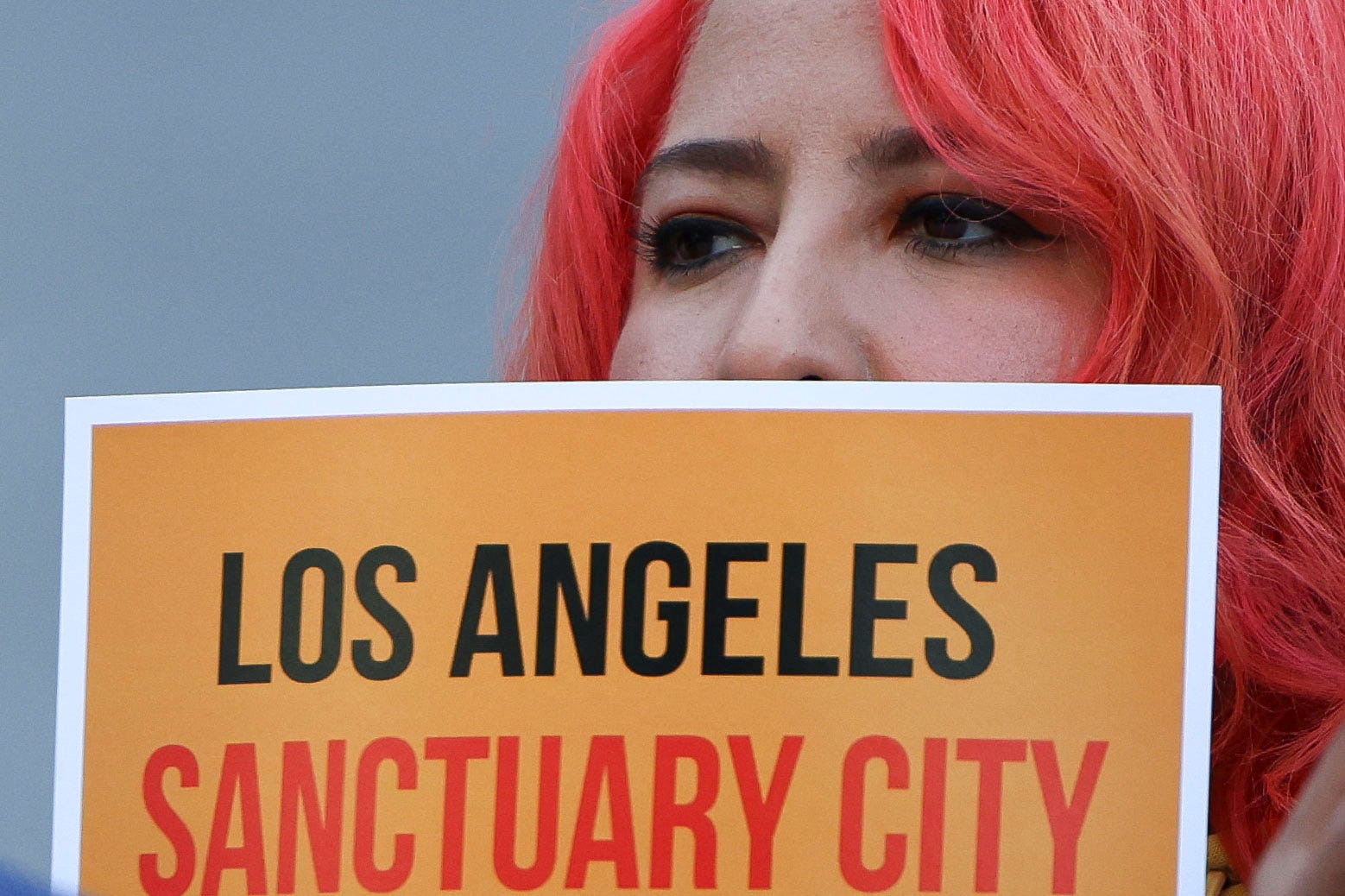 A protester attends a pro-immigration rally as the Los Angeles City Council meets to consider adopting a "Sanctuary City'' ordinance on Nov. 19, 2024.