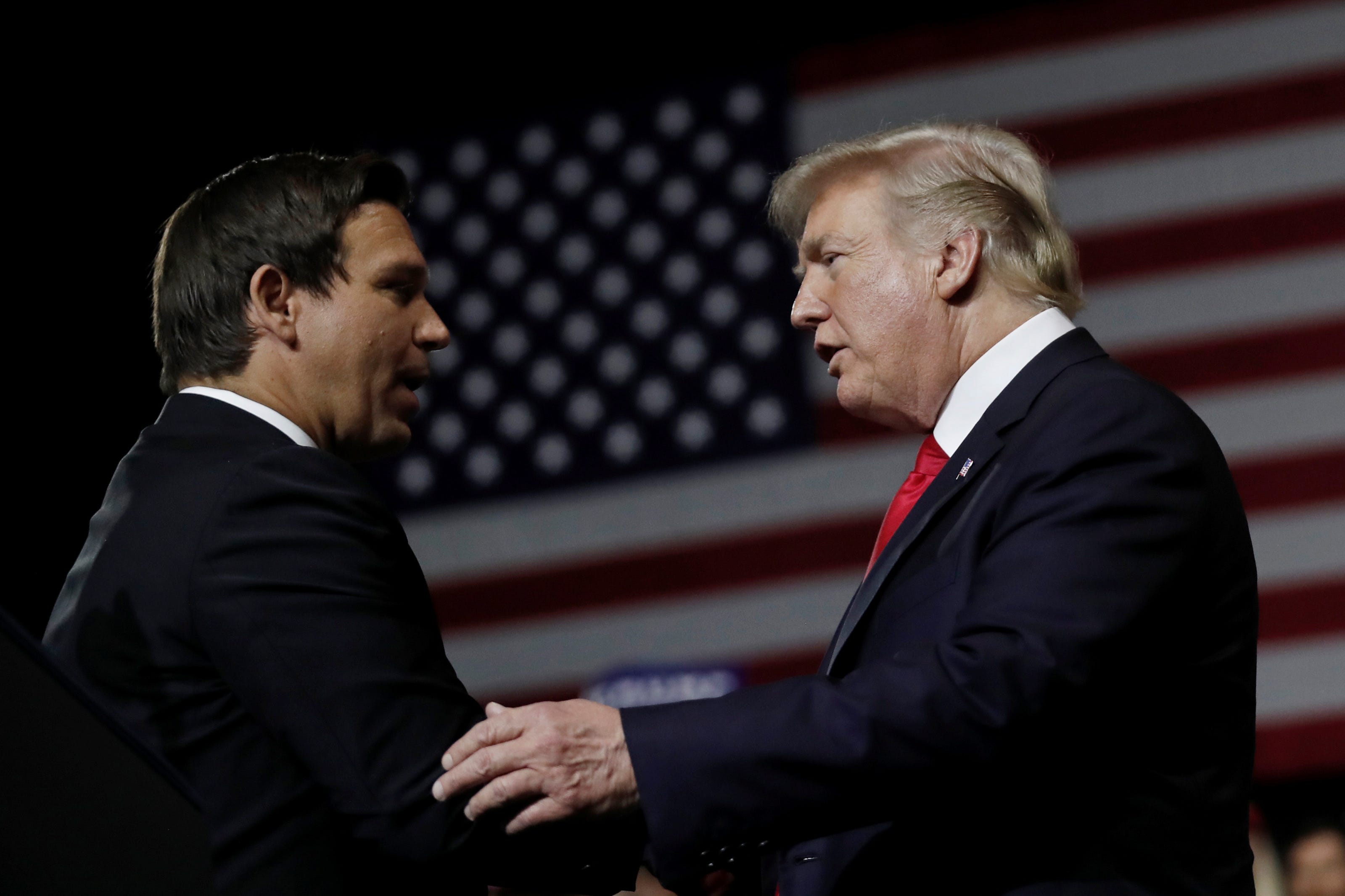 U.S. President Donald Trump talks with Republican Florida governor candidate Ron DeSantis during a Make America Great Again Rally at the Florida State Fairgrounds in Tampa, Florida, U.S., July 31, 2018.