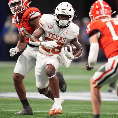 Texas running back Quintrevion Wisner (26) rushes the ball against Georgia during the first half in the 2024 SEC championship game at Mercedes-Benz Stadium.