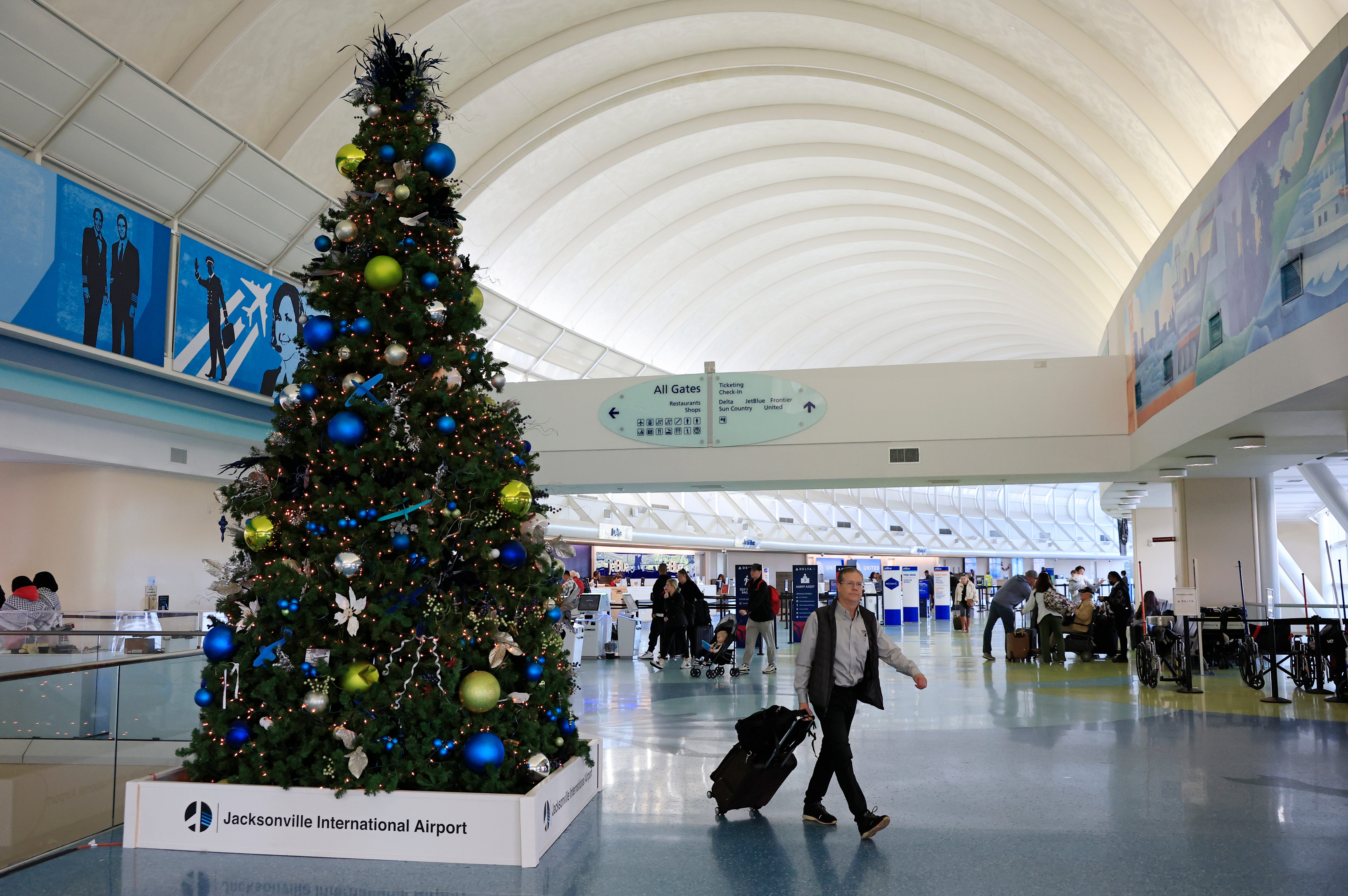 Travelers come and go Tuesday, Dec. 3, 2024 at Jacksonville International Airport in Jacksonville, Fla.