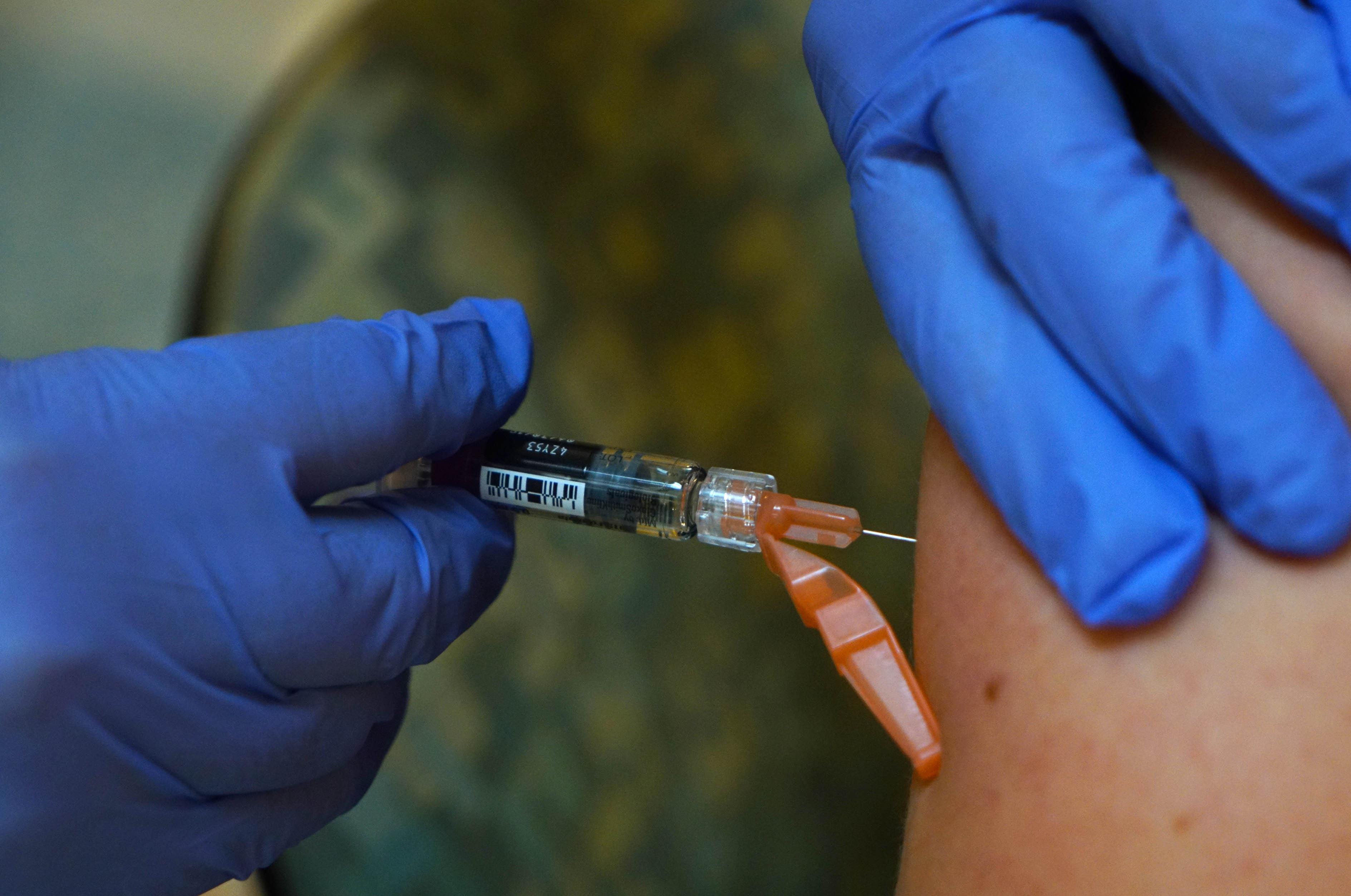 A Christiana Care employee gets a flu shot on Thursday morning during a mass vaccination drive in 2018.