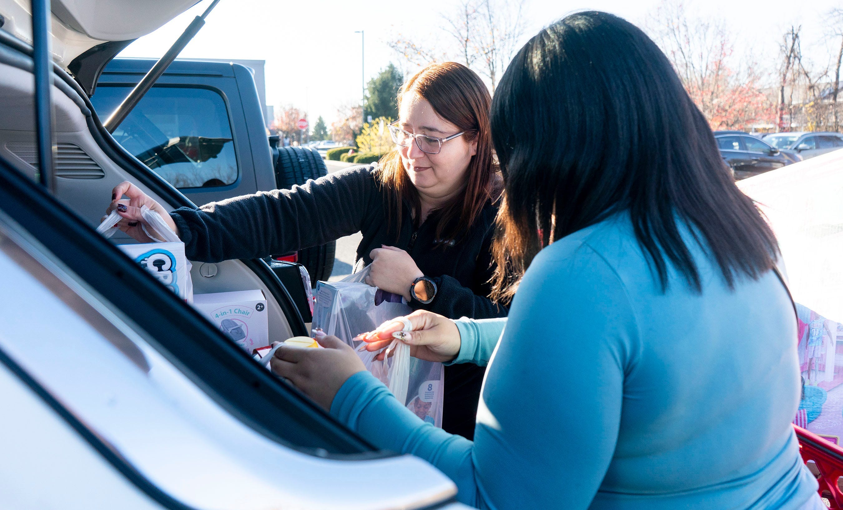 Betzy Hernandez, left, from Levittown, and Nicole Concepcion, right, from Philadelphia, pack up their car after holiday shopping at the Target in Langhorne on Friday, Nov. 29, 2024.