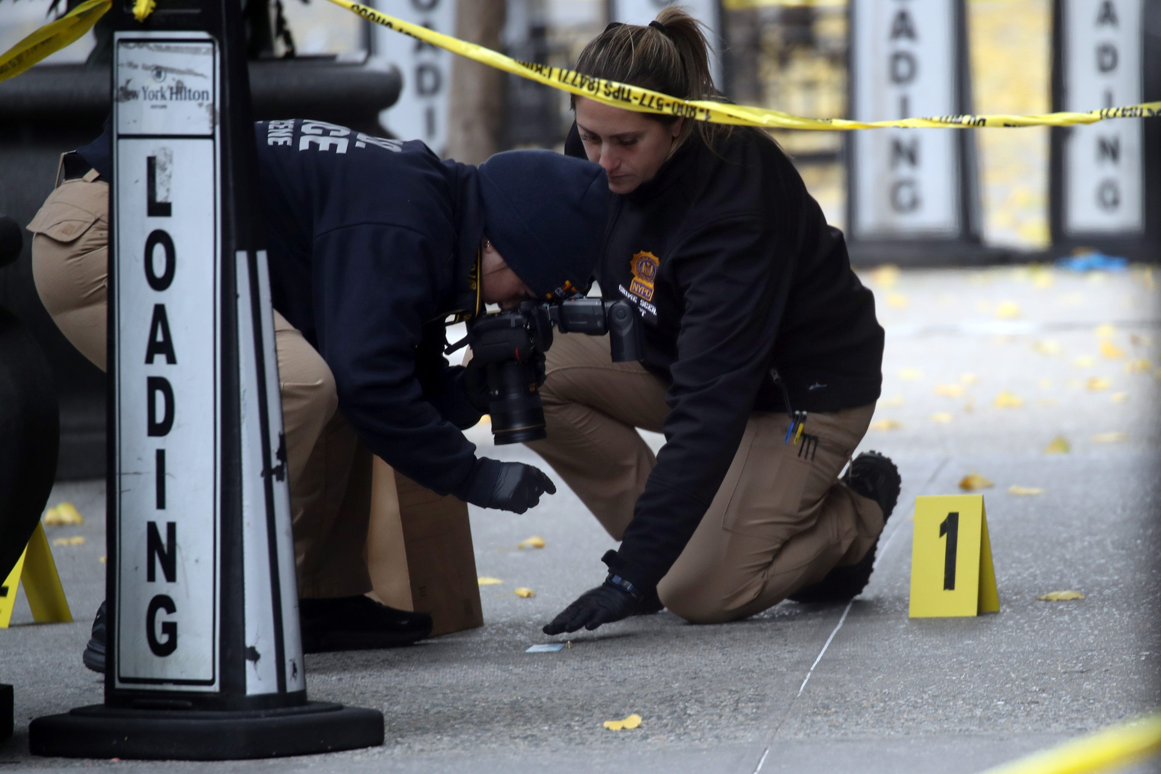 NEW YORK, NEW YORK - DECEMBER 04: Police place bullet casing markers outside of a Hilton Hotel in Midtown Manhattan where United Healthcare CEO Brian Thompson was fatally shot on December 04, 2024 in New York City. Brian Thompson was shot and killed before 7:00 AM this morning outside the Hilton Hotel, just before he was set to attend the company's annual investors' meeting. (Photo by Spencer Platt/Getty Images)