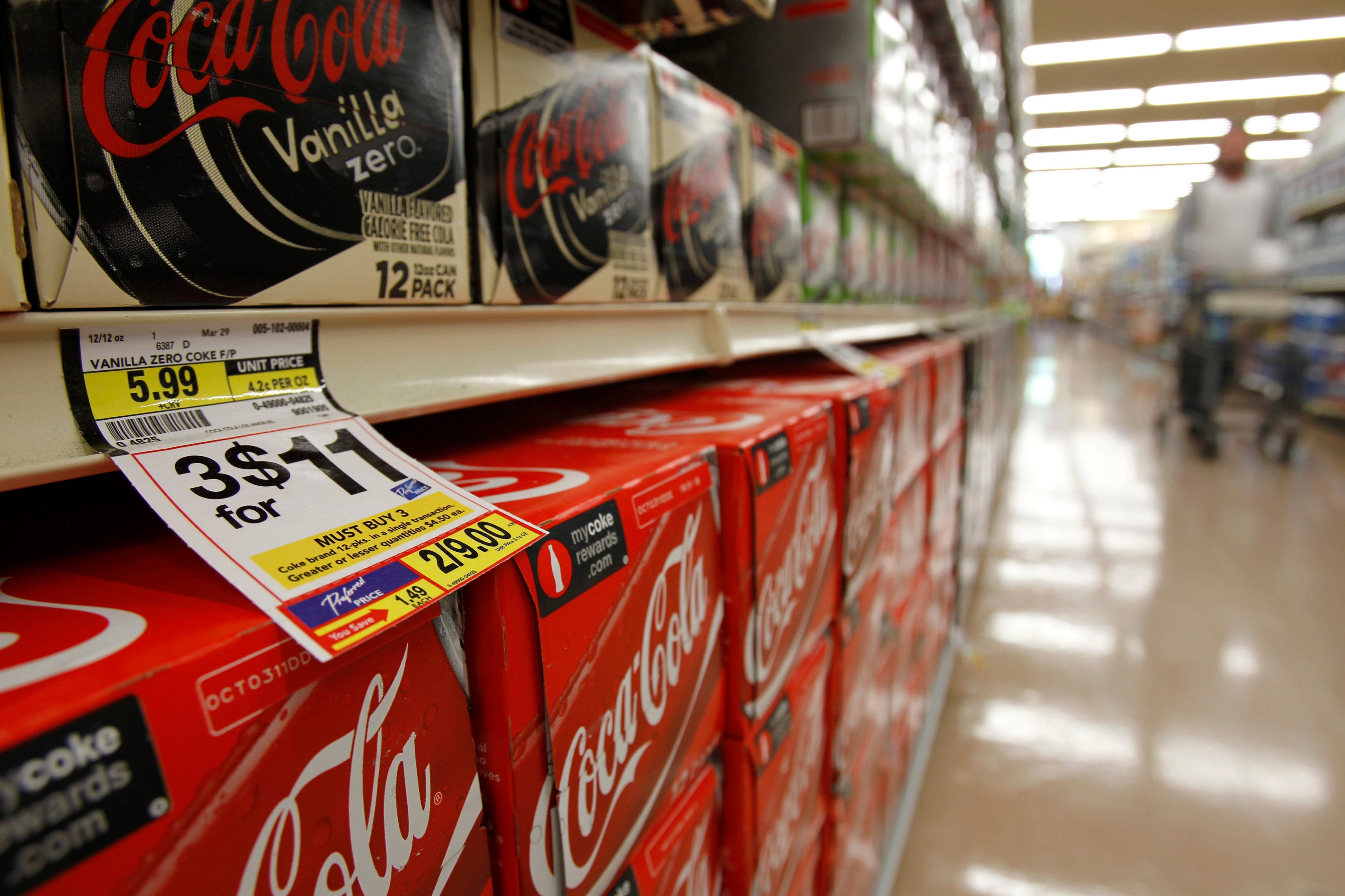 A shopper walks by the sodas aisle at a grocery store in Los Angeles April 7, 2011. On the streets of America, the debate over inflation is over. Prices are too high and rising too fast, many people say. But policy-makers at the U.S. Federal Reserve largely agree that promoting economic growth is still more urgent that constraining a nascent pick-up in consumer prices.