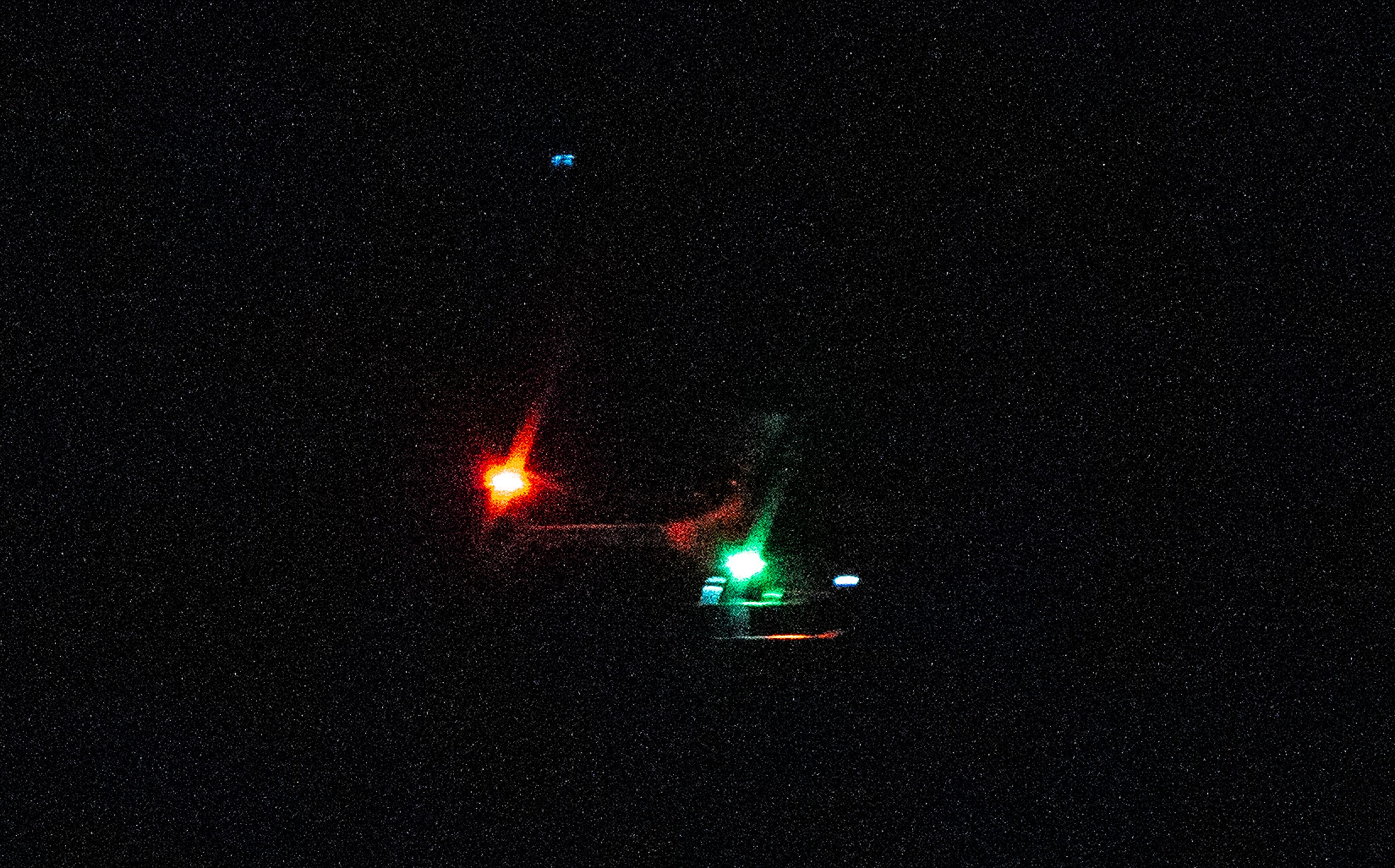 Photos taken in the bayside section of Toms River, NJ of what appear to be large drones hovering in the area at high altitudes. The drones were photographed between 8:33 p.m. and 8:49 p.m. on Dec. 8, 2024. The drones seemed to be well above the 400-foot height FAA regulations allow. This object in the sky was thought to be a helicopter, but there was no audible sound associated with it.