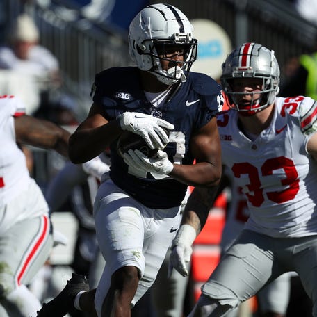 Penn State running back Nicholas Singleton (10) runs with the ball during the second quarter against Ohio State at Beaver Stadium.