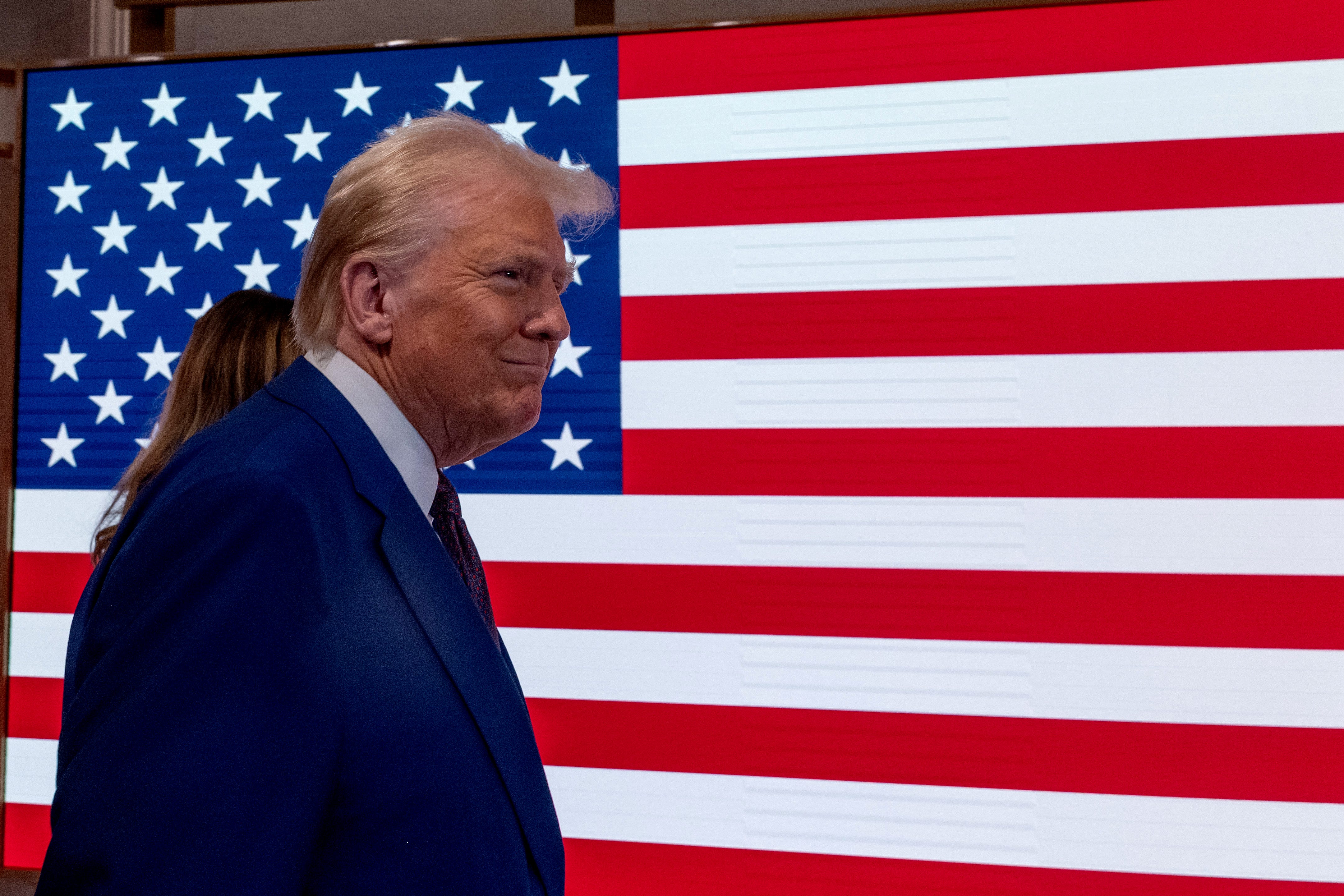 President-elect Donald Trump walks onto the floor of the New York Stock Exchange (NYSE) with his wife Melania after being named TIME's 