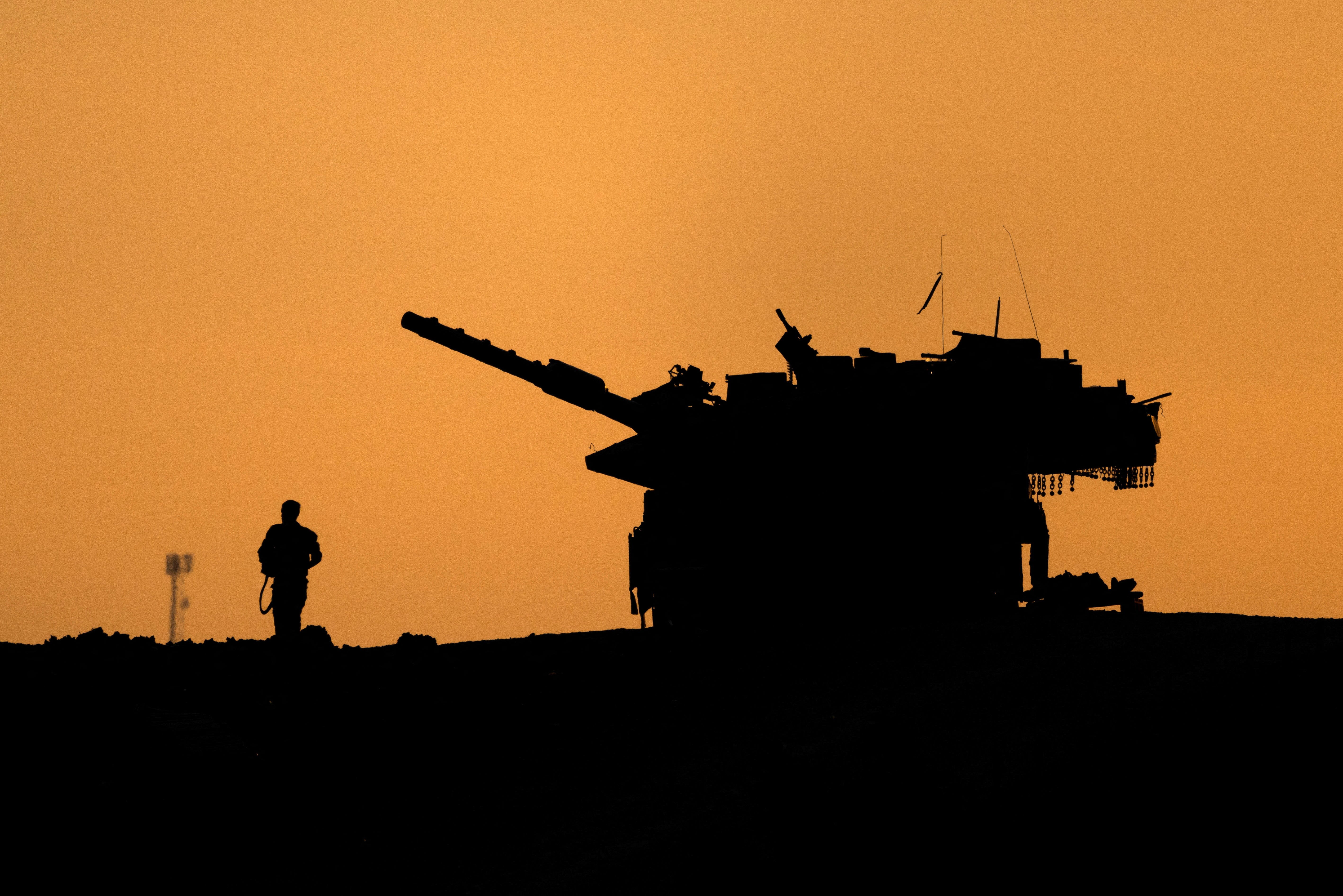 The silhouettes of a military vehicle and a soldier are seen near the Gaza border with in Israel, on Dec. 16, 2024. REUTERS/Amir Cohen
