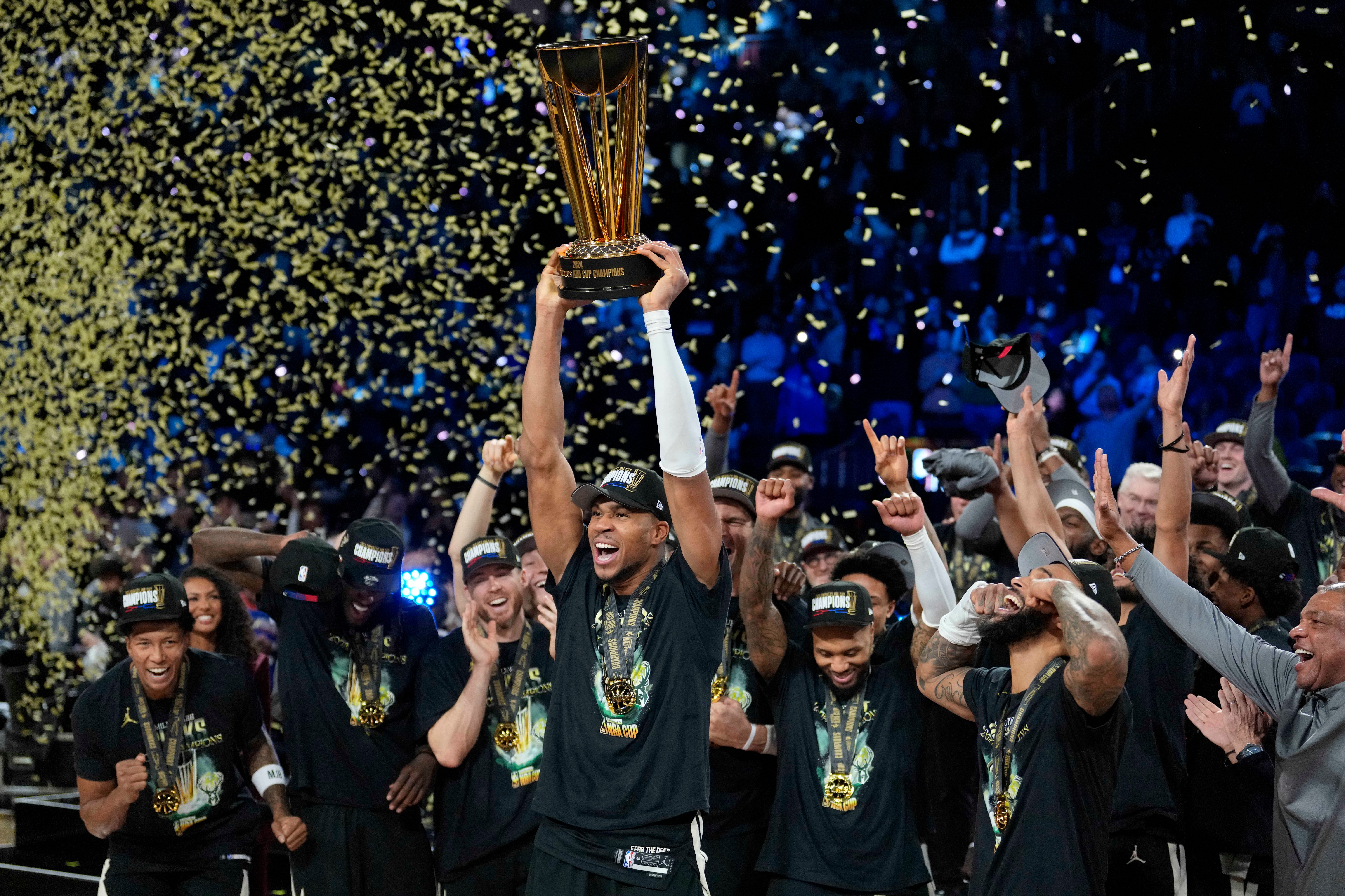 Milwaukee Bucks star Giannis Antetokounmpo lifts the NBA Cup.