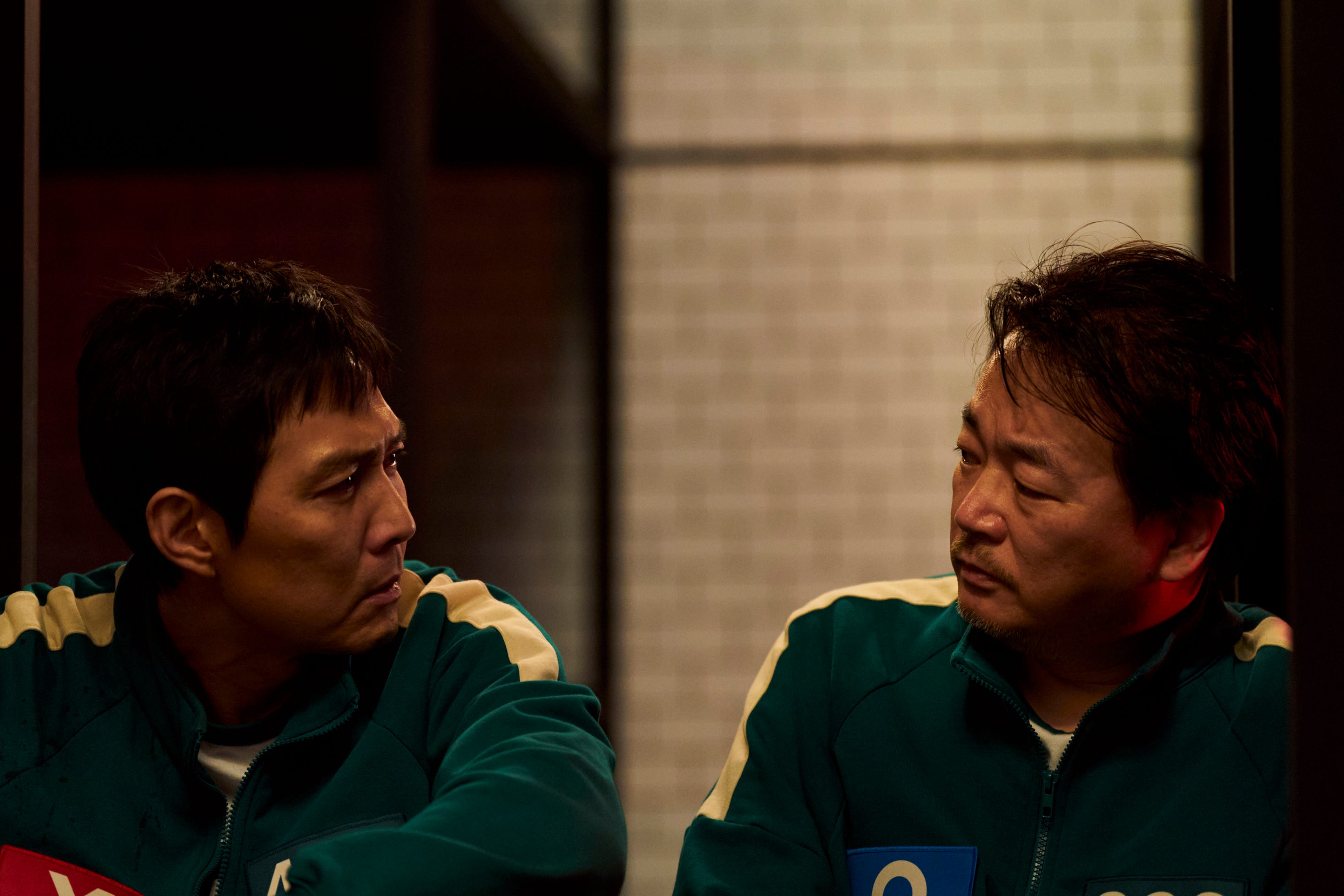 Lee Jung-jae as Seong Gi-hun and Lee Seo-hwan as Jung-bae in "Squid Game."