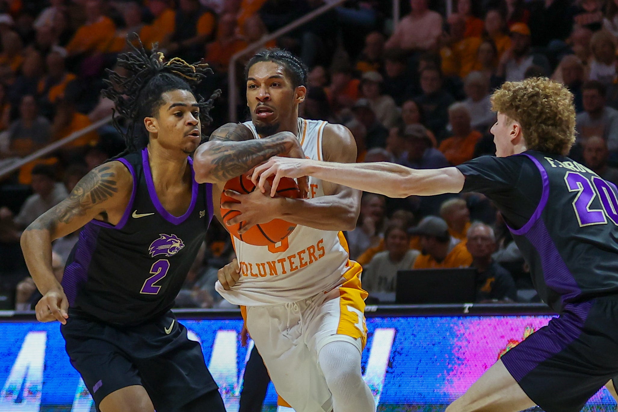 Tennessee guard Zakai Zeigler (5) dribbles past Western Carolina guard CJ Hyland (2) and guard Fischer Brown (20) during the first half at Thompson-Boling Arena at Food City Center.