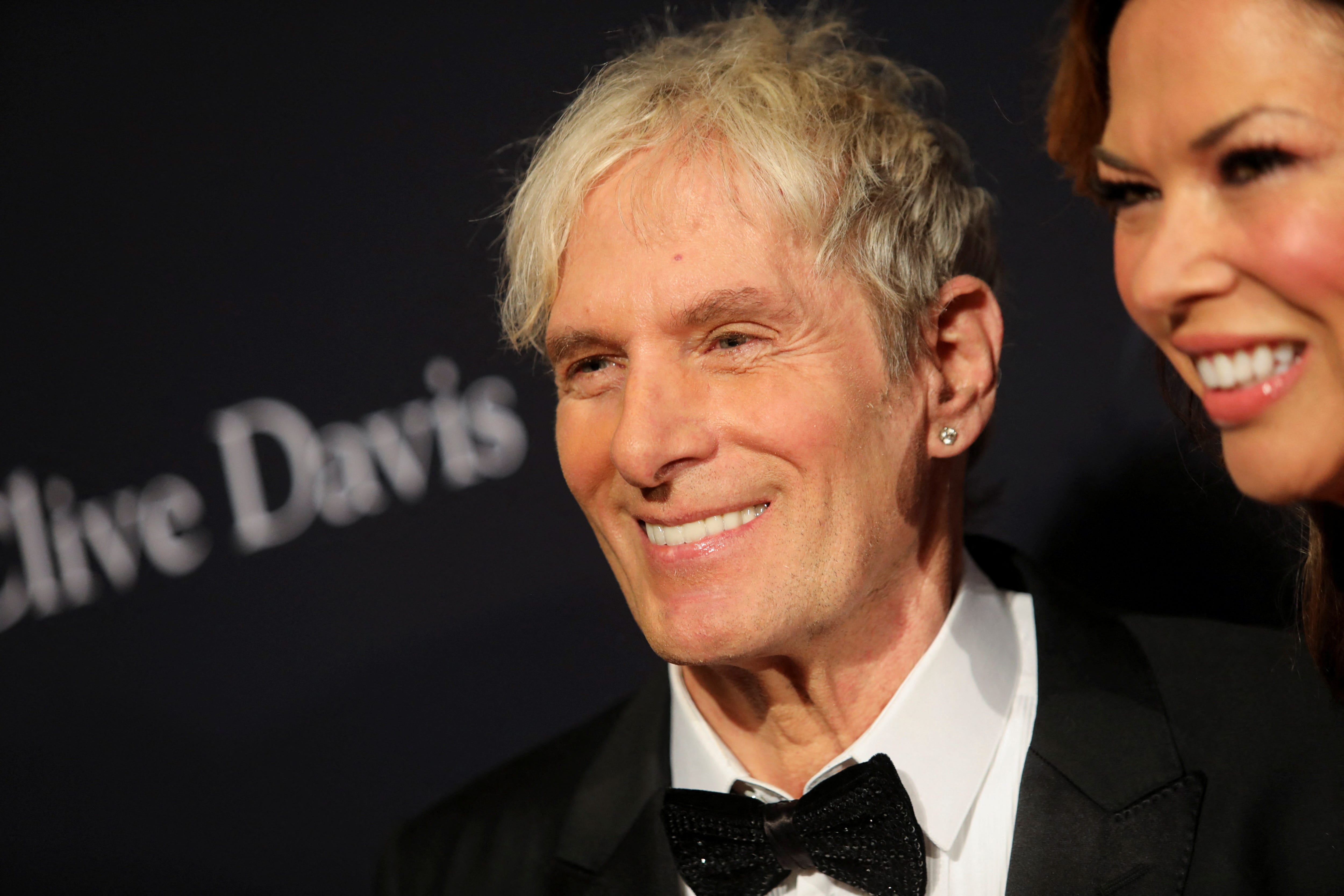 Michael Bolton, center, and Heather Kerzner attend the Pre-Grammy Gala in Beverly Hills, Los Angeles, Feb. 4, 2023.