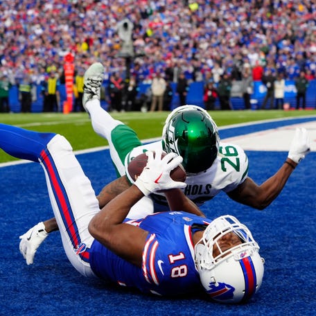 Buffalo Bills wide receiver Amari Cooper crashes into the turf after his acrobatic, 30-yard touchdown catch Dec. 29, 2024, against New York Jets cornerback Brandin Echols. Cooper was evaluated for a concussion after he was slow in getting up.