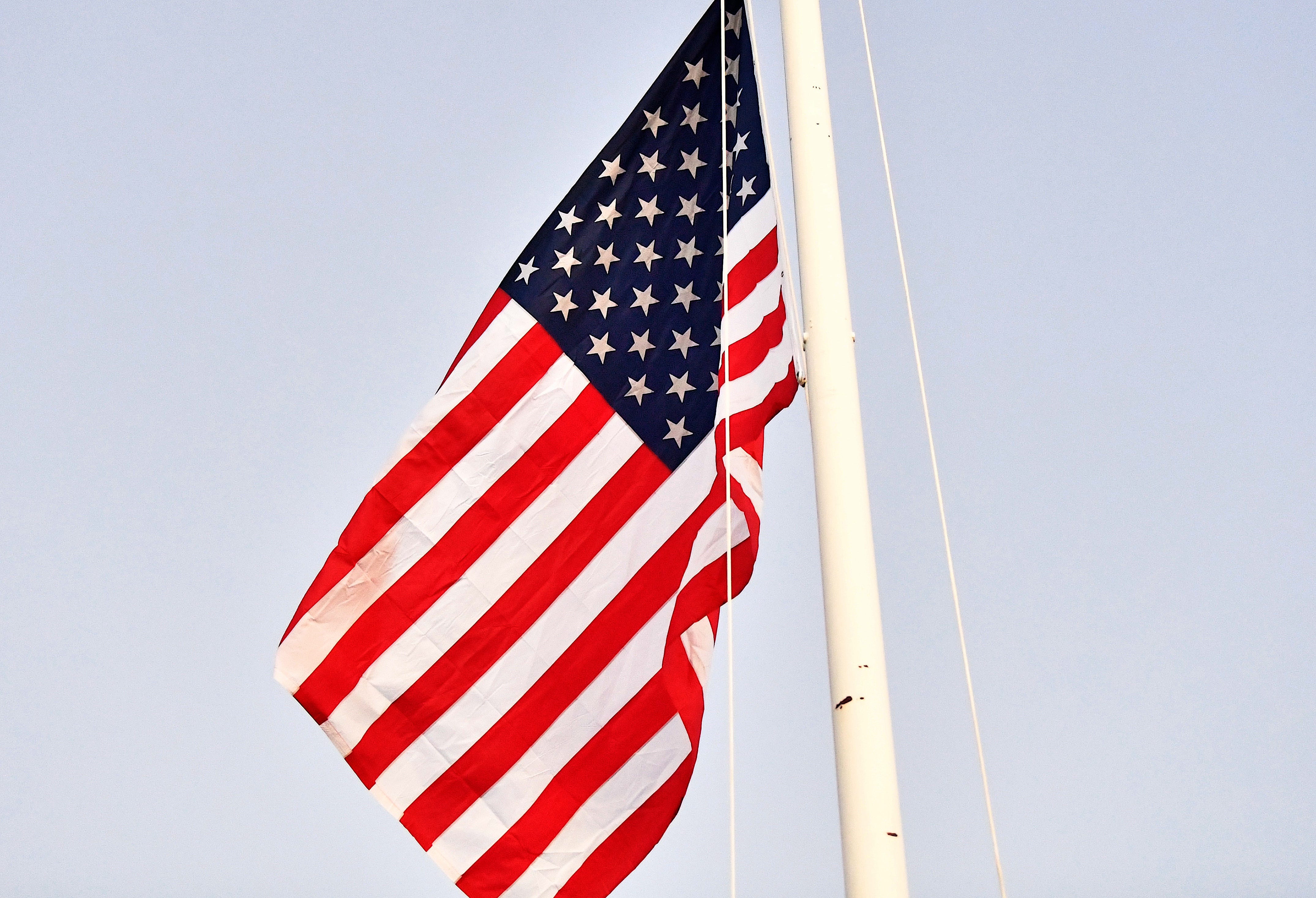 The American flag is adjusted to half-staff during a 9/11 memorial ceremony at Sheppard Air Force Base on Wednesday, Sept. 11, 2024.