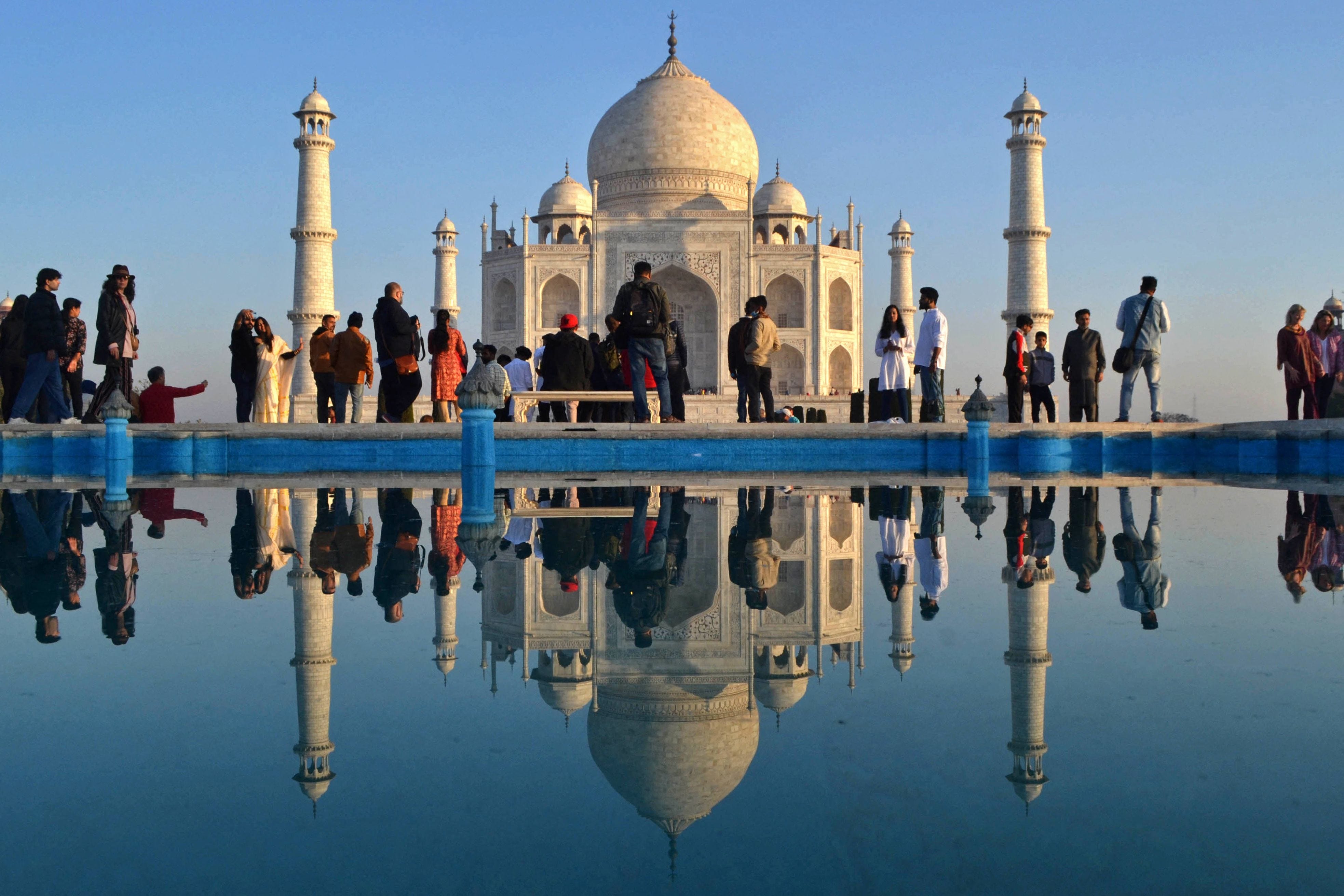 Tourists visit the Taj Mahal during early morning in Agra on February 15, 2023.