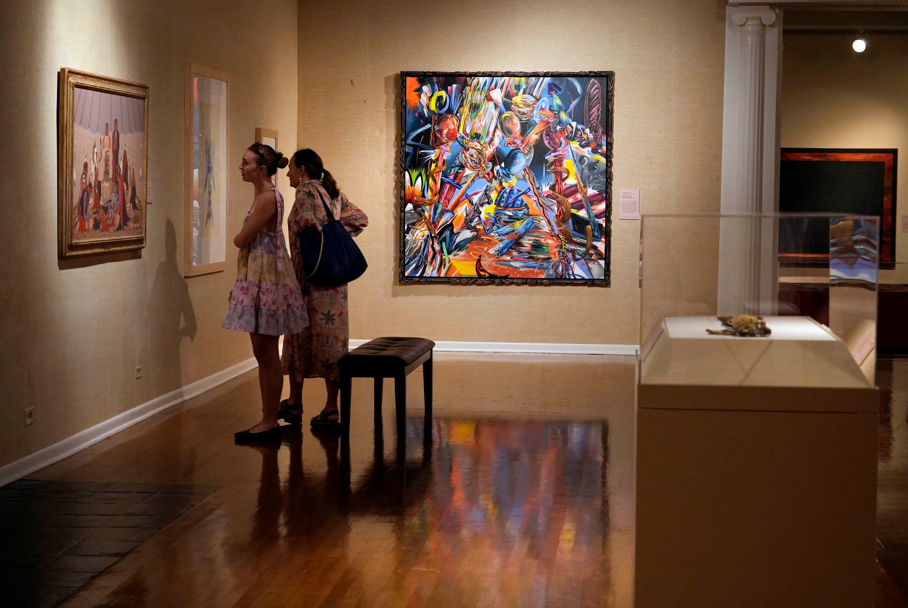 Visitors study pieces from the Past Forward Native American Art From Gilcrease Museum at The Society of the Four Arts Friday January 3, 2025 in Palm Beach.