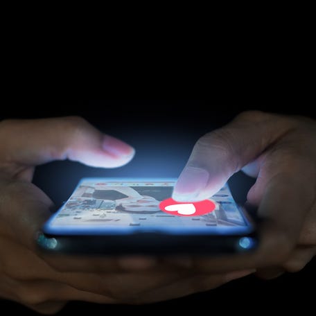 Someone using a phone for a dating app.