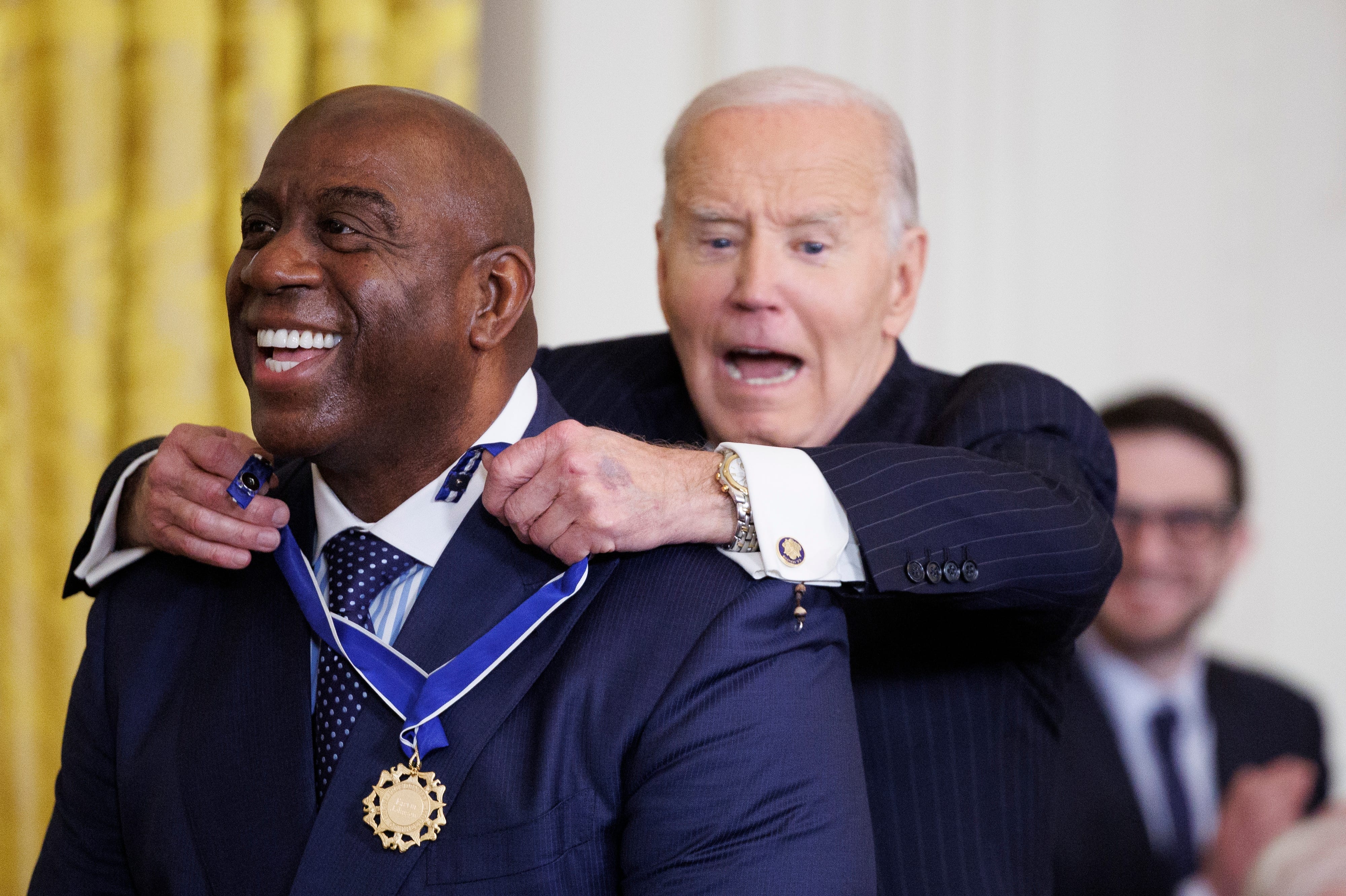 President Joe Biden reacts while awarding Former NBA player Earvin "Magic" Johnson the Presidential Medal of Freedom in the East Room of the White House on January 4, 2025 in Washington, DC. President Biden is awarding 19 recipients with the nation's highest civilian honor.