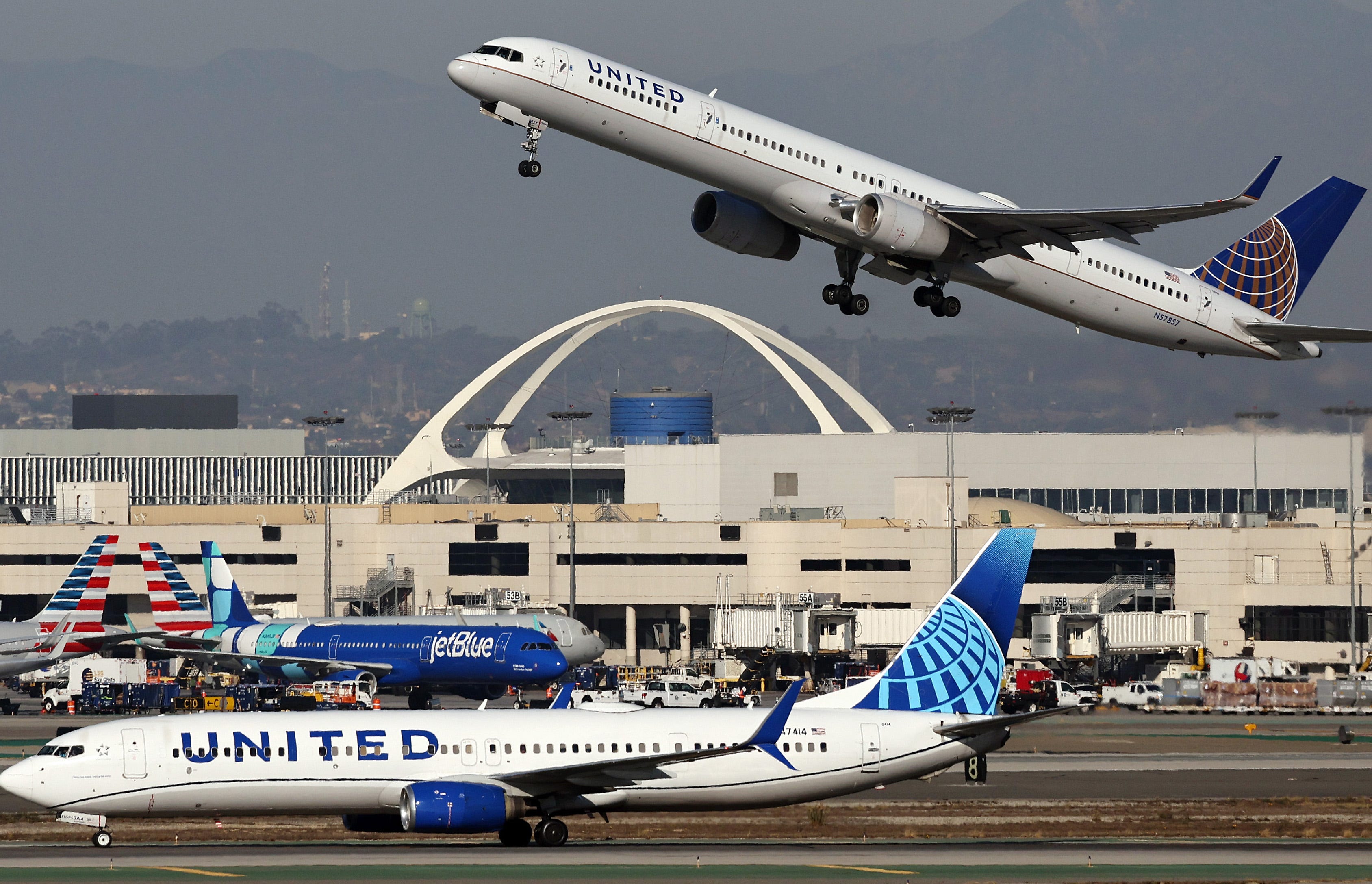 A United Airlines plane takes off as another taxis at Los Angeles International Airport (LAX) following the Thanksgiving holiday on December 2, 2024 in Los Angeles, California.