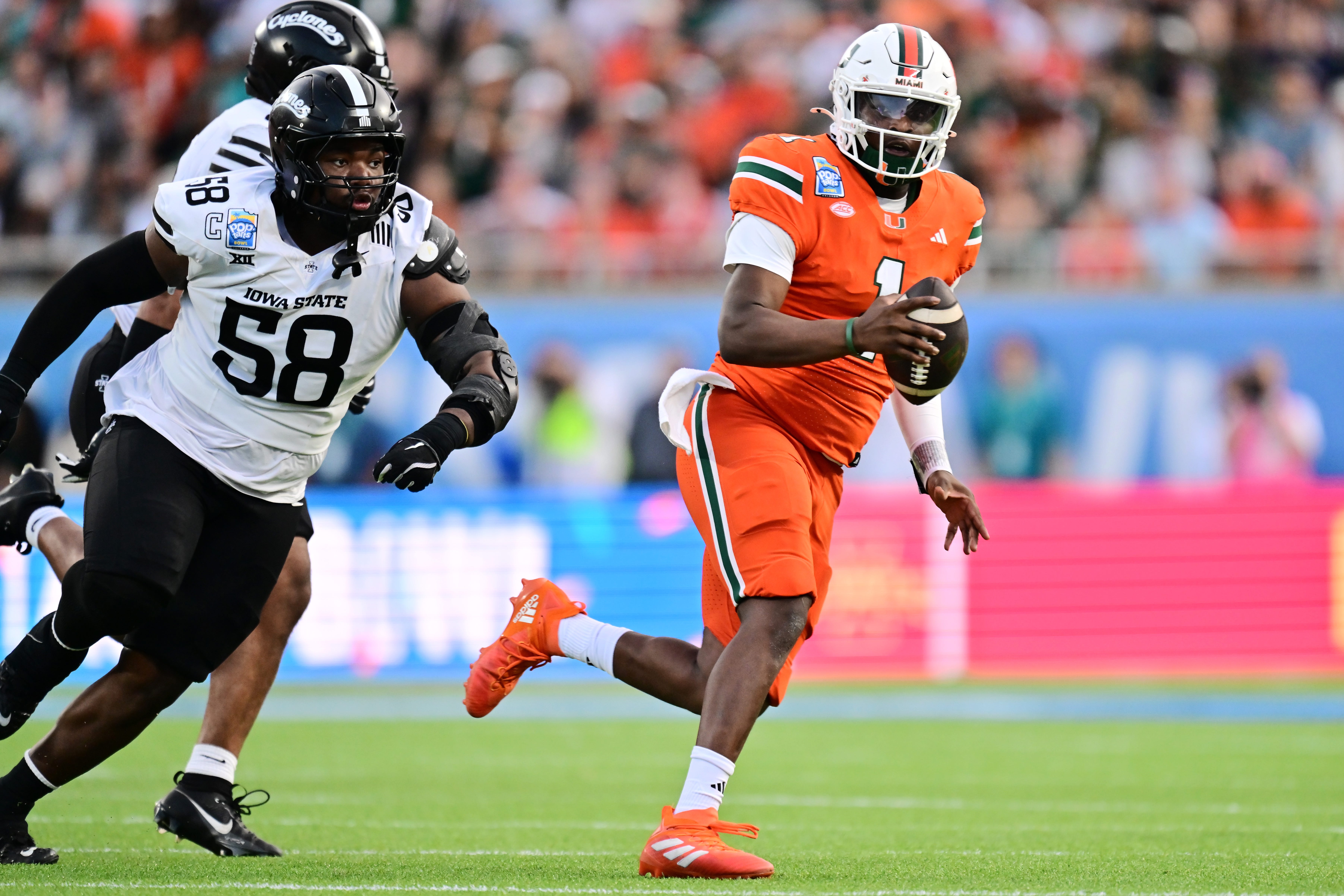 Cam Ward #1 of the Miami Hurricanes scrambles with the ball in the second quarter against the Iowa State Cyclones during the 2024 Pop-Tarts Bowl at Camping World Stadium on December 28, 2024 in Orlando, Florida.
