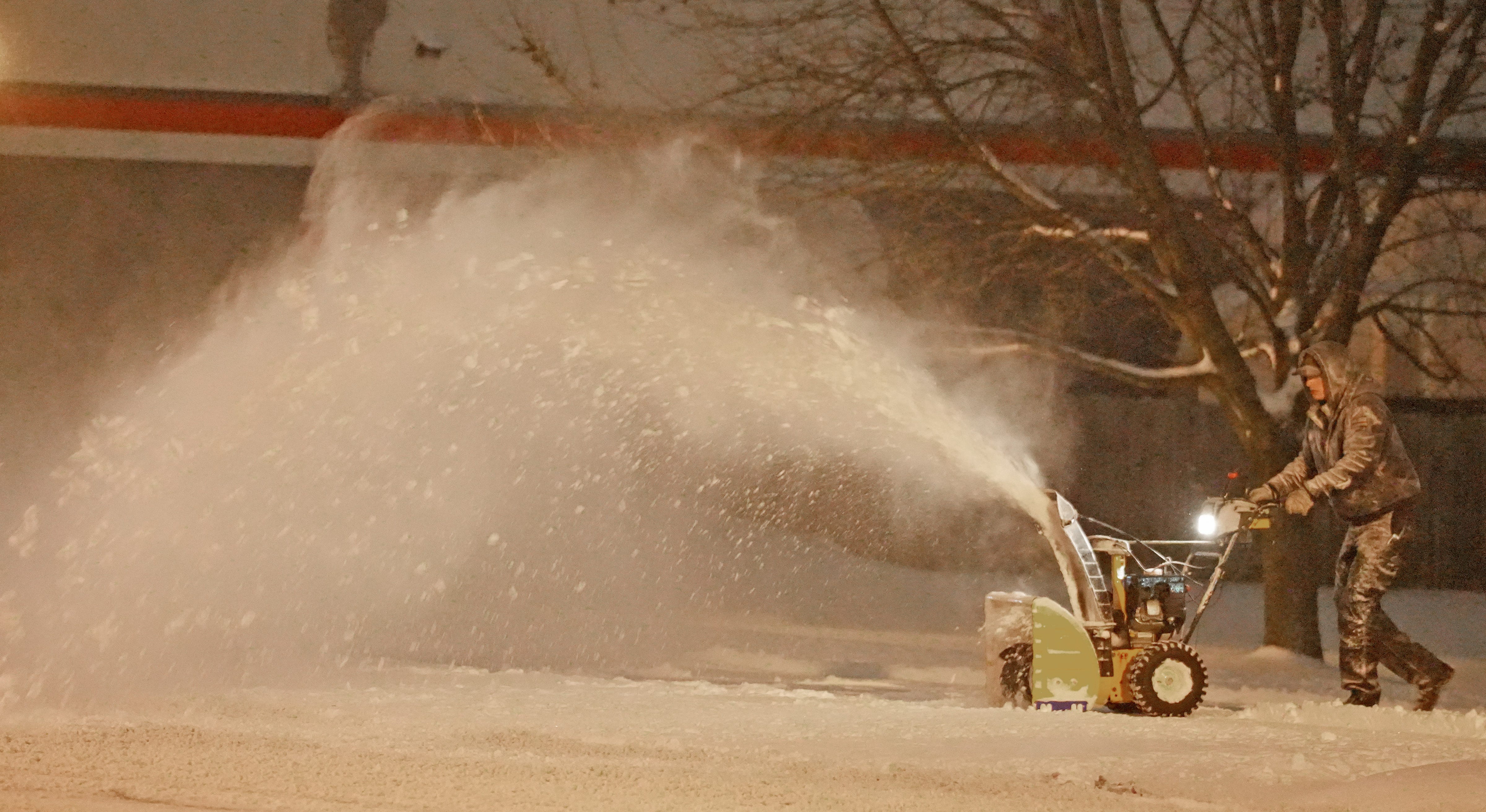Columbus firefighter Dominic Colatruglio clears snow around Fire Station 19 in Clintonville. Several inches of dry, fluffy snow hit the Columbus area Monday morning January 6, 2025.